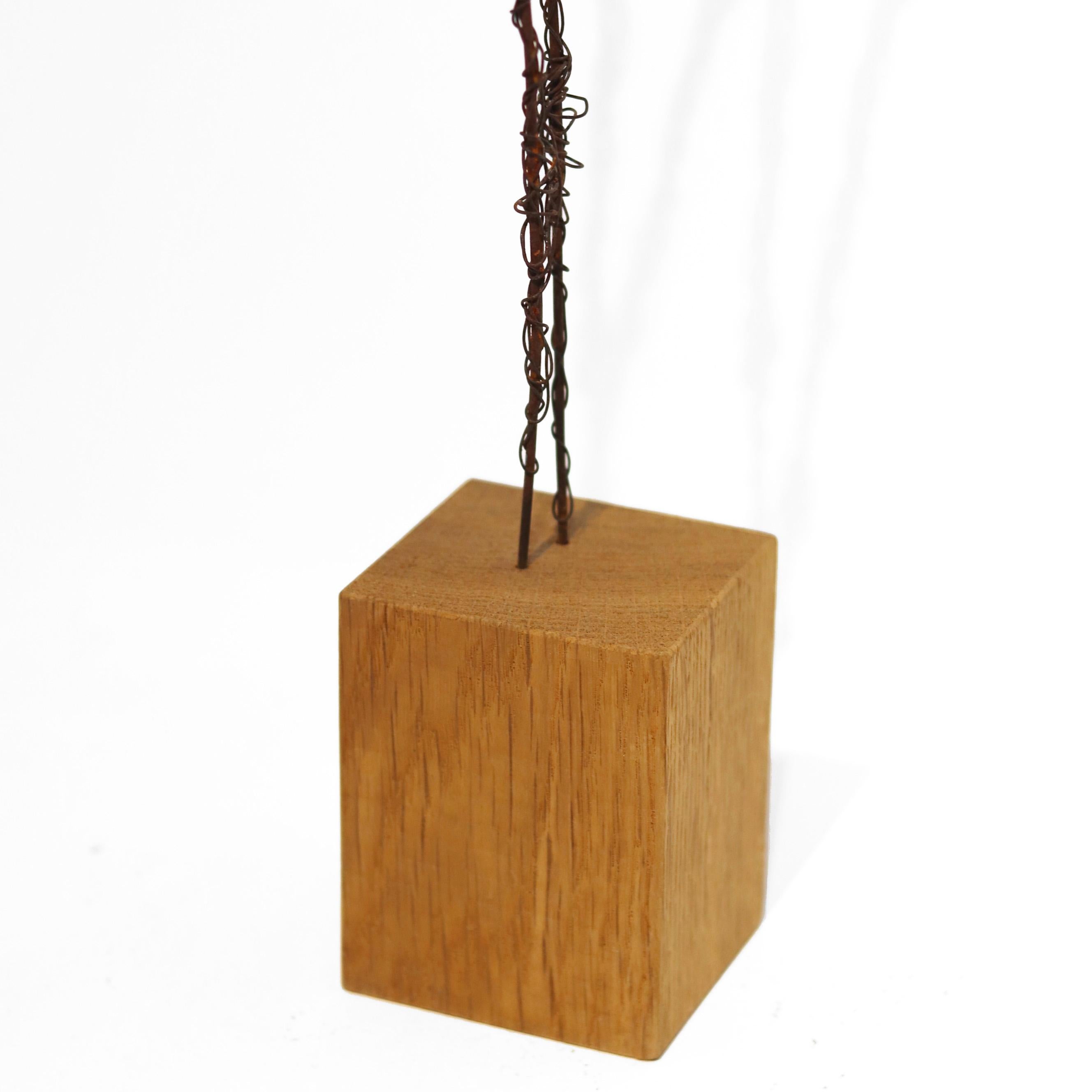 Susy Hunziker's metal figures are the result of exploring form, colors, and feelings, and reflect a love of life and aesthetics. Rust brown iron wire is wound meticulously in varying thicknesses, creating abstract sculptural figures. Her work is