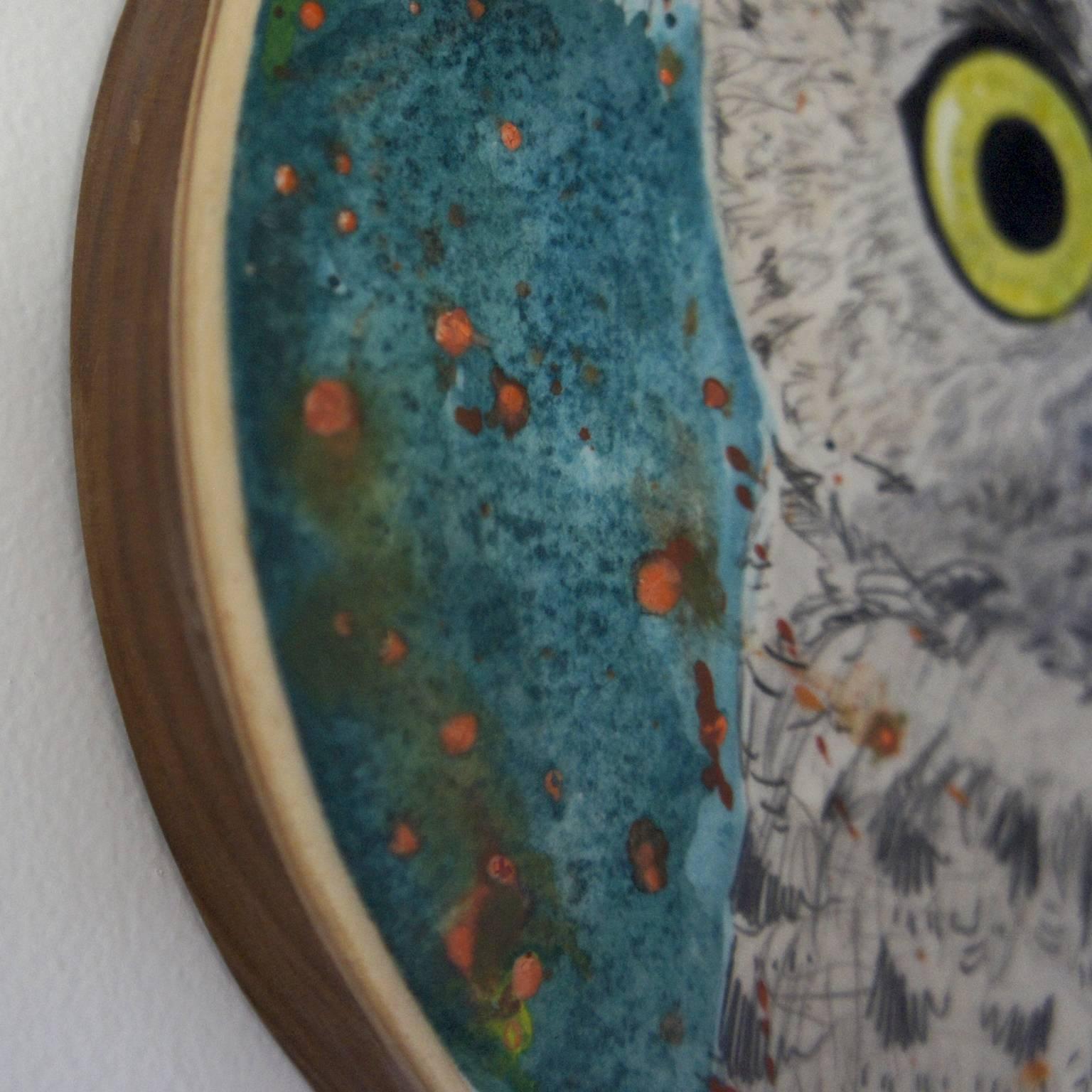 Gin Stone's “Walter” is an 8 x 8 x 1 inch watercolor, graphite and wax mixed media painting on paper mounted on a round birch wood panel and is part of a series of nature studies. The great horned owl has highly detailed eyes and feathers and is