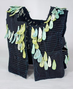 "Envy", mixed media, vest, ceramic, black, green, teal, white, sculpture