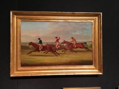 English horse racing scene with three horses and jockeys in mid gallop