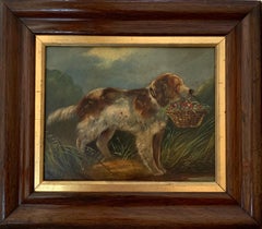 English Victorian portrait of a Spaniel dog holding a basket in a landscape.