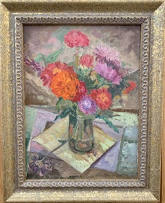 Still life of Red and Orange Flowers in a glass vase on a table