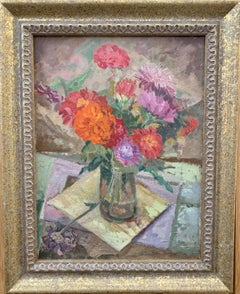 Still life of Red and Orange Flowers in a glass vase on a table 