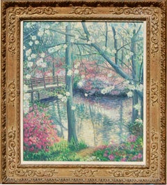 20th century Impressionist river landscape with trees in blossom by a bridge