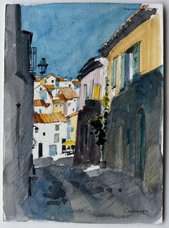 Sonnenbeschienene Straße in Cucuron mit Terrakotta-Dächern und verschlossenen Häusern Aquarell