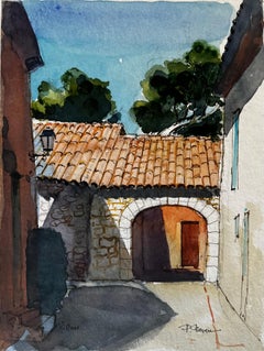 Arco del villaggio francese con tetto di tegole e cortile Acquerello