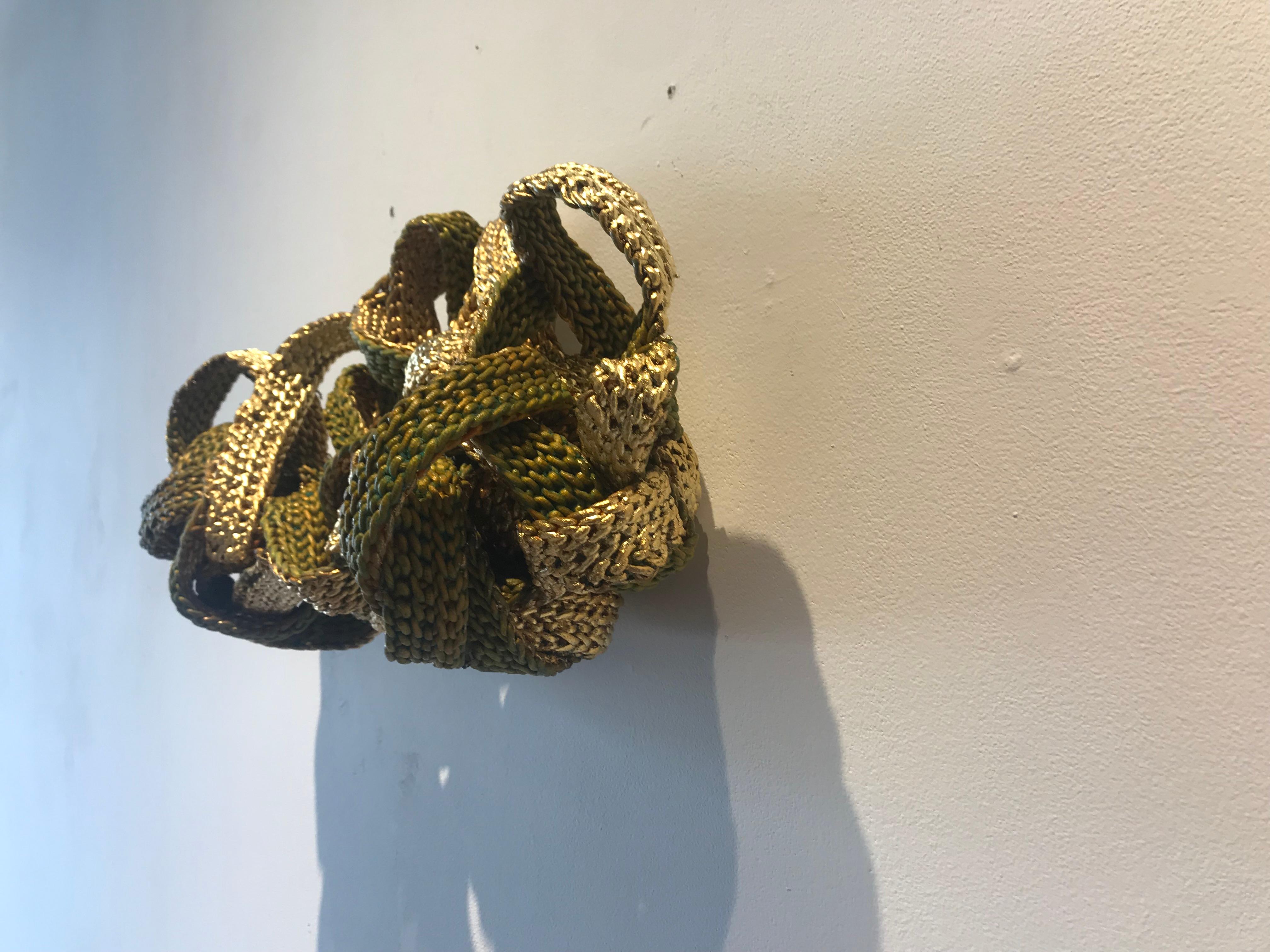Louise Pappageorge's artwork incorporates found and newly created crochet and laces to construct sculptural bodies of work that are metal leafed and patinaed. She views these dimensional artworks as a dialogue about the initial feminized craft