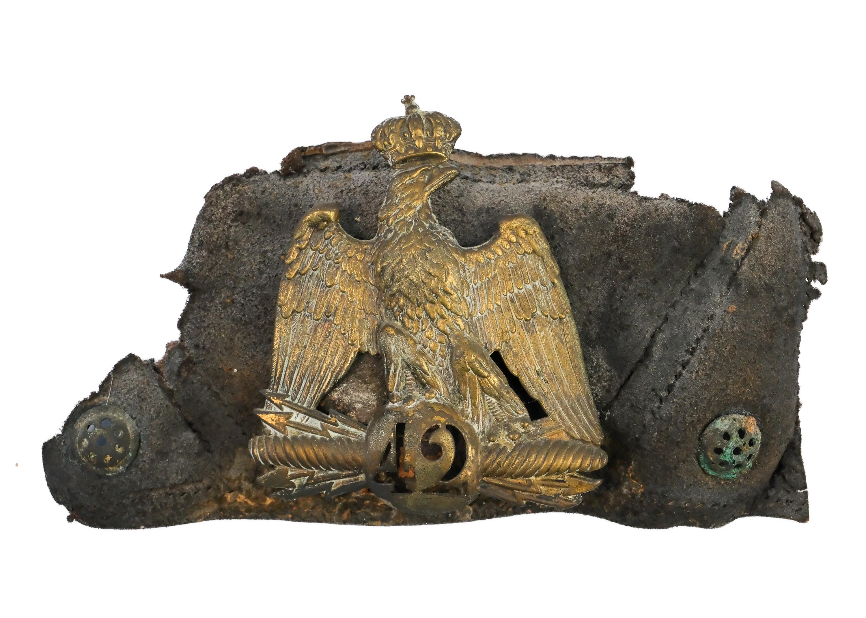 19th Century French Shako
Partial Shako from Napoleon’s 42nd Infantry Regiment
1869
Brass and leather
Dimensions: 7 1/4 x 11 1/2 x 3 inches (18.2 x 29 x 8 cm)
Handmade display case

This brass plate of the French Imperial Eagle belonged to a member