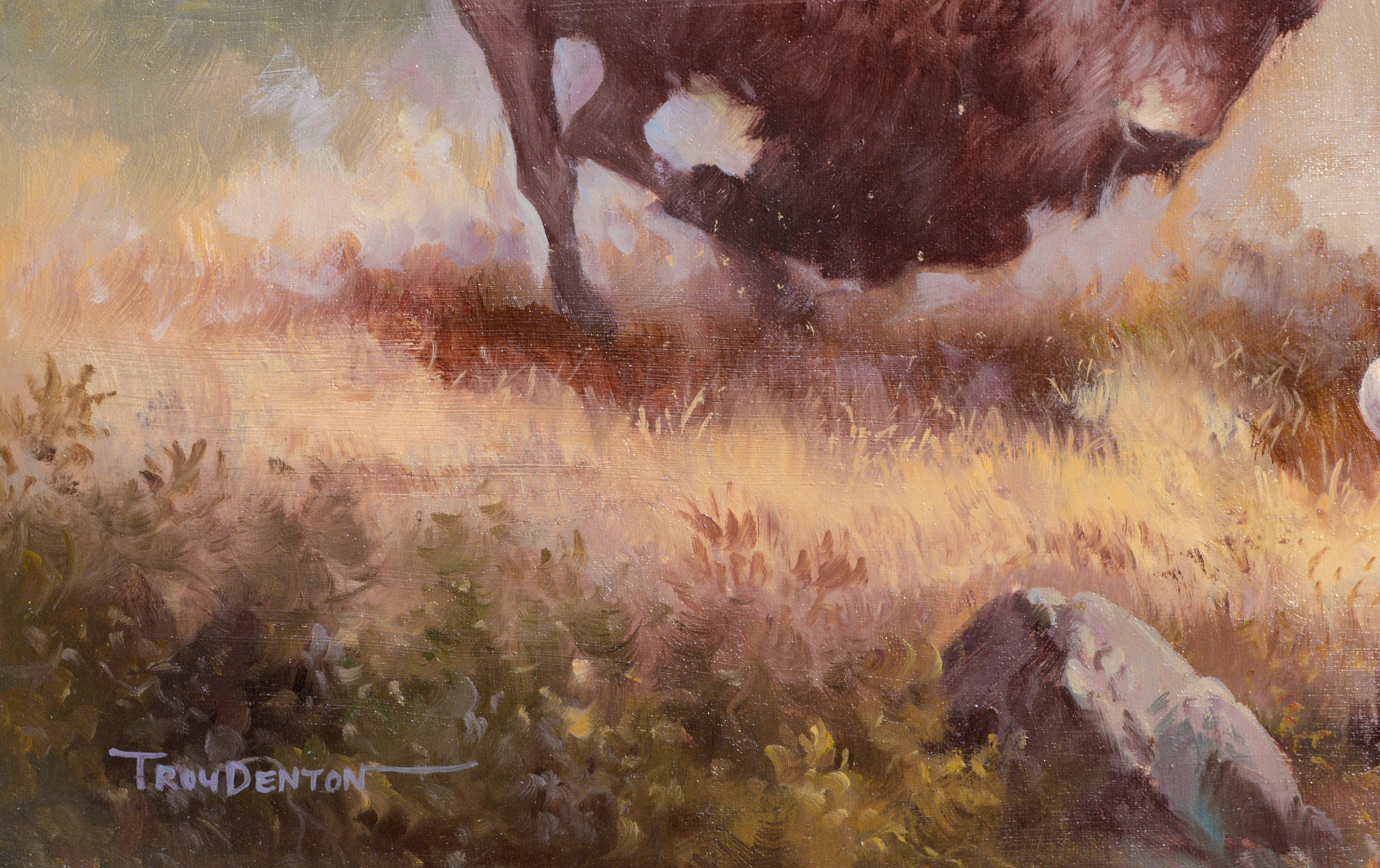 A dynamic hunting scene is portrayed in this realist figurative landscape by Troy Denton (unknown) (20th Century). A Native American holding a rifle rides a white horse, with a heard of huge writhing buffalo on either side. Signed 