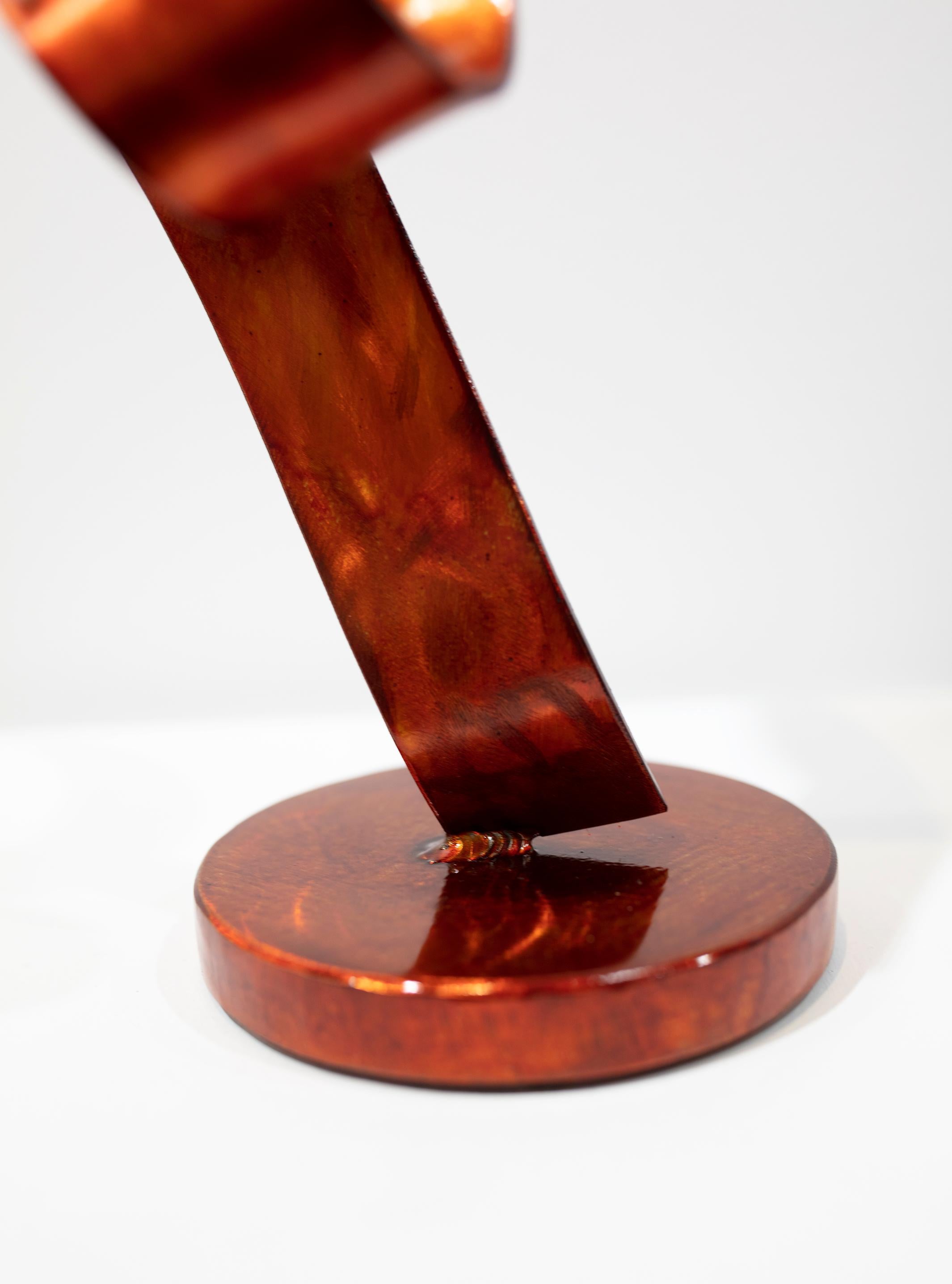 Orange Swirl is a tabletop sculpture made out of steel with an orange dye and clear coat. 

Connecticut sculptor Joe Sorge says about his work, 