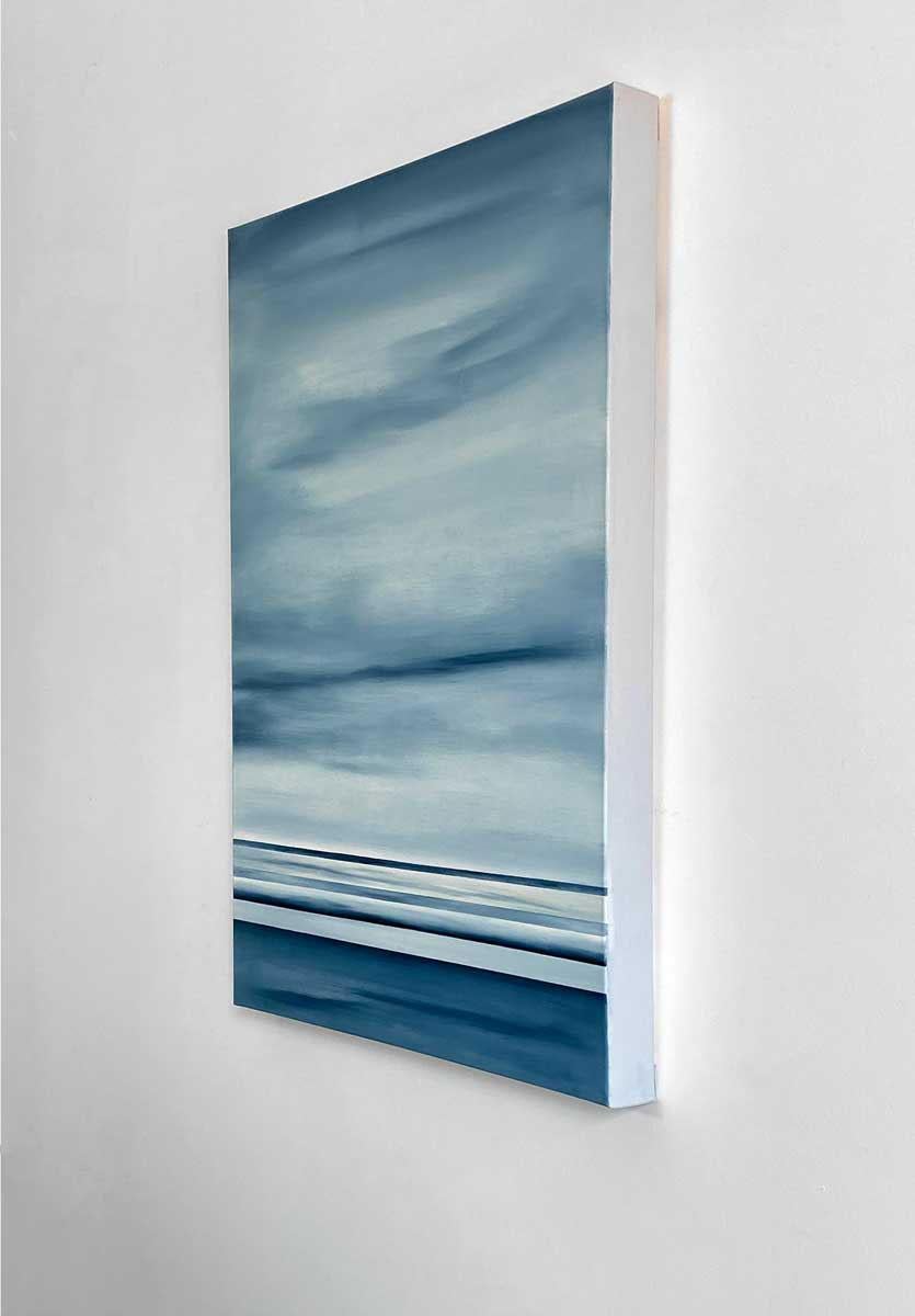 This original abstract painting by Tony Iadicicco is made with oil paint on gallery wrapped canvas. Primarily blue, grey, and white, this piece features parallel horizontal lines along the bottom portion of the composition, with the top