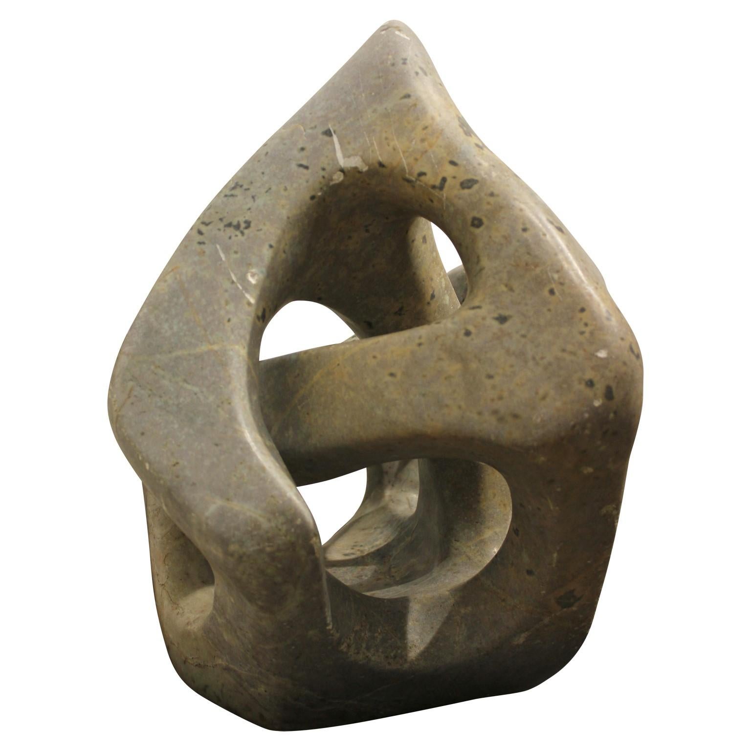 Organic geometric sculpture made from stone. It has natural tones within the stone that consist of yellows and greens. Goncalvez is a sculpture artist known for his abstract works. 