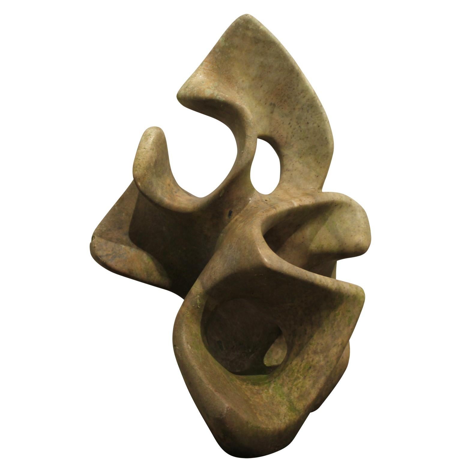 Organic shaped abstract sculpture made out of stone. Sculpture has natural toned from the rock.