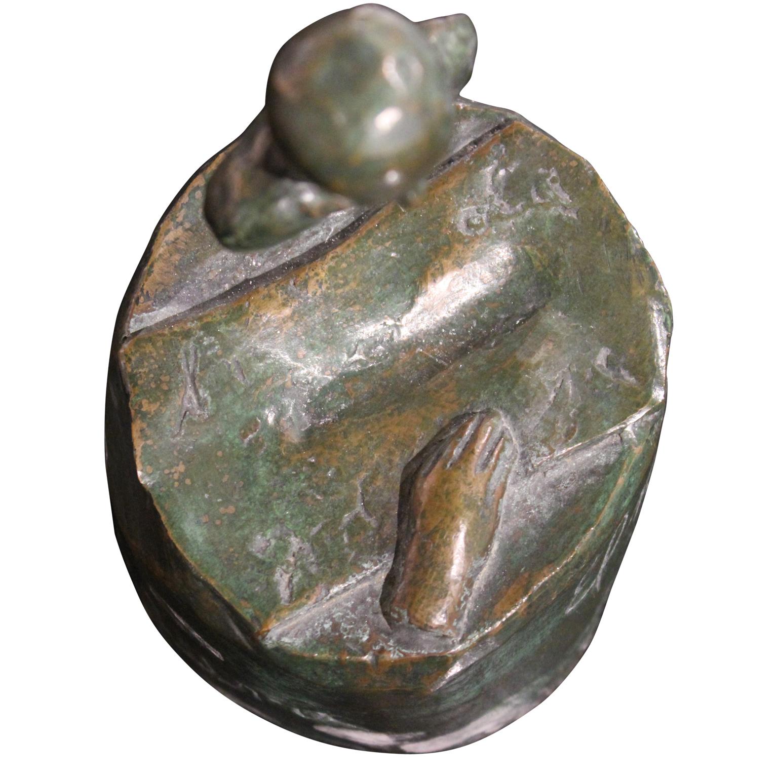 Surrealist bronze sculpture of a figure hovering above the water looking at a disembodied hand. On the base there is the phrase 