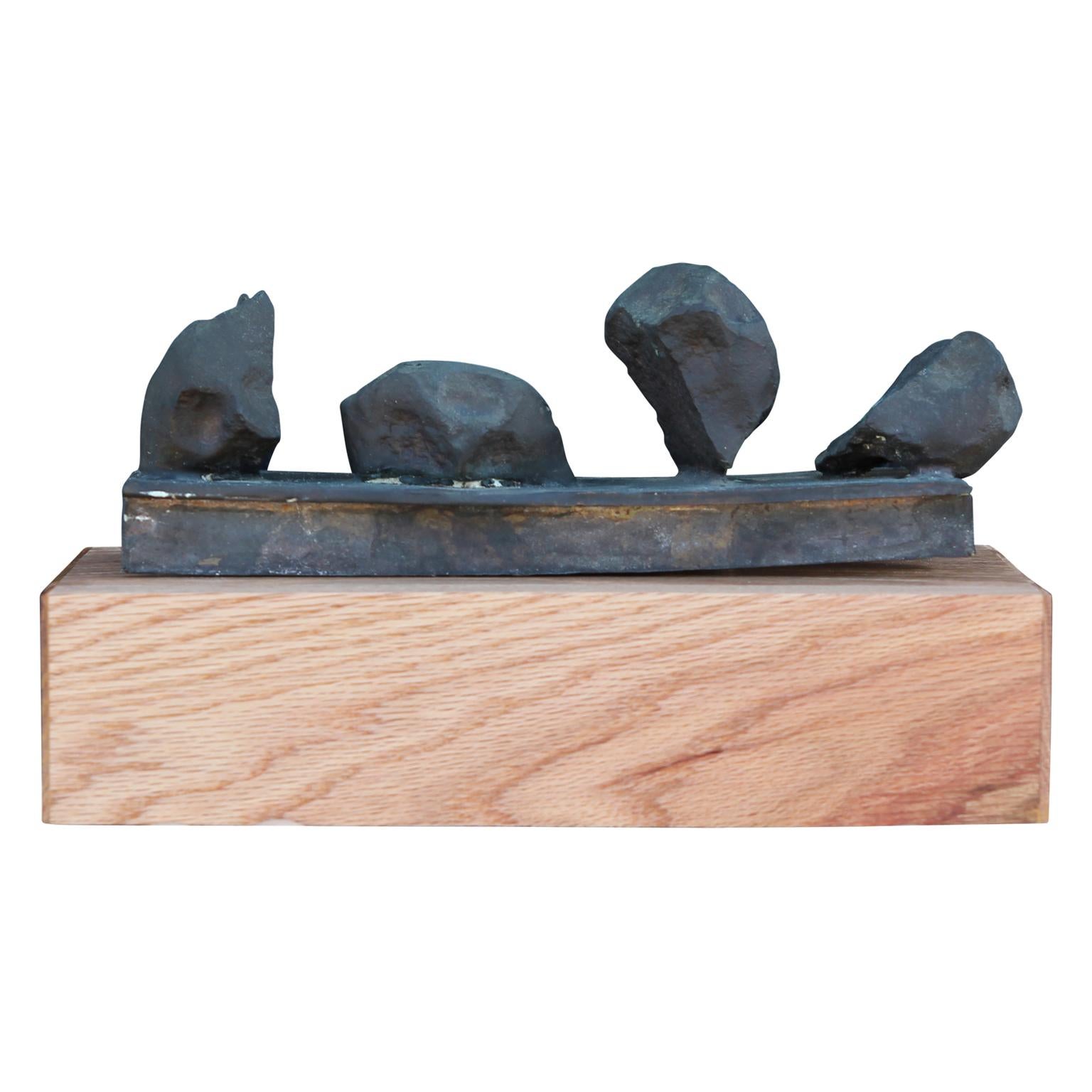 Brutalist bronze sculpture with four organic massed atop a bronze base. The sculpture sits on a hand made wooden base. The work is signed and dated by the artist Rick Pasterchik who was known for abstract sculptures and painting.
Dimensions without