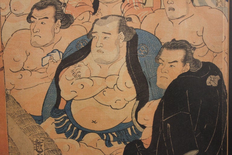 Intricate Japanese woodblock print triptych of a sumo match between the wrestlers Inazuma and Abumatsu in the the dohyo, or sumo ring, by the popular artist Utagawa Kunisada in the 1840's. 

Artist Biography:
Kunisada was born in 1786 in Honjo, an