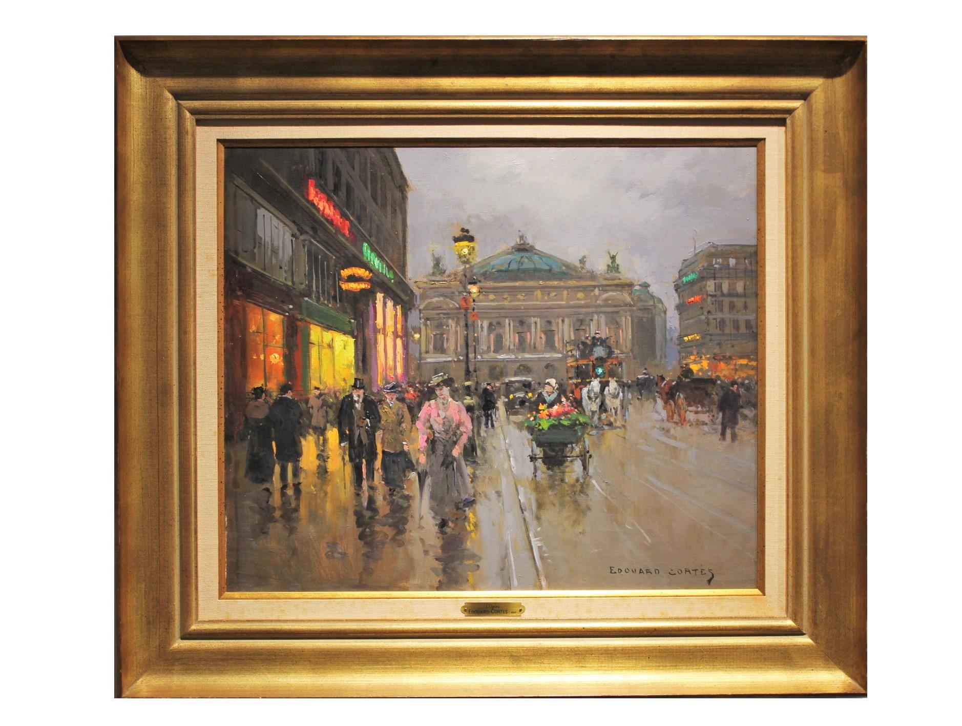 French impressionist cityscape of a busty street corner with figures walking in the direction of the viewer. The painting is attributed to Edouard Cortes and is signed in the bottom corner. The canvas is framed in a gold frame with a burlap matte.
