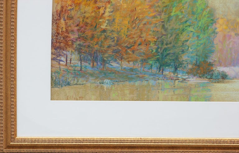 Abstract impressionist oil pastel landscape by Colorado artist, Ken Elliott. Yellow and green pastel toned drawing depicting a lakeside with glowing trees in autumn. Framed and matted in a gold frame. Signed by artist at the bottom left.

Dimensions