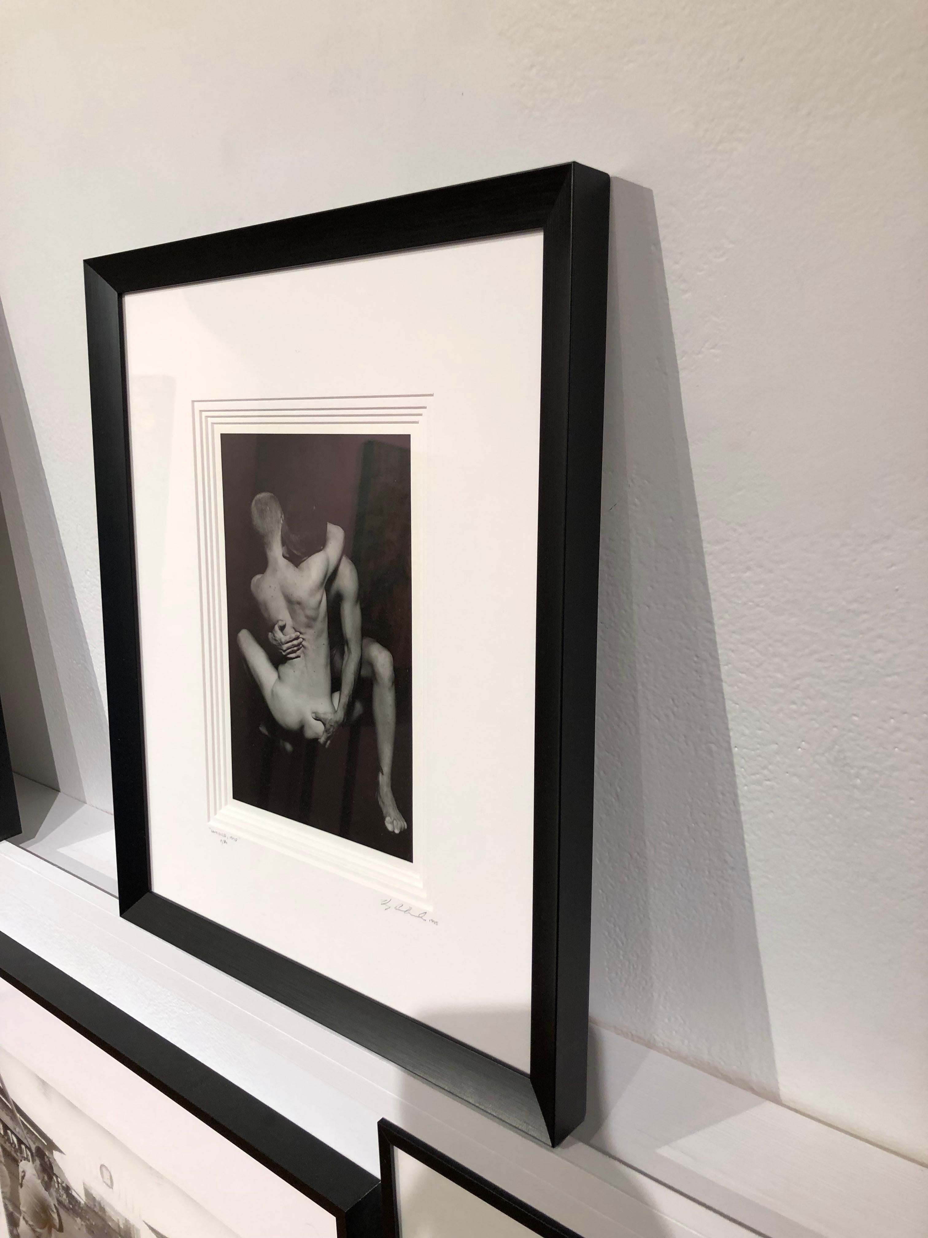 This intimate photograph shows two figures embracing, their faces are hidden, adding to its mystery.  The photo is matted in black and framed in a dark silver frame with non reflective museum glass.

Doug Birkenheuer
Untitled (Stone & Miles)
silver