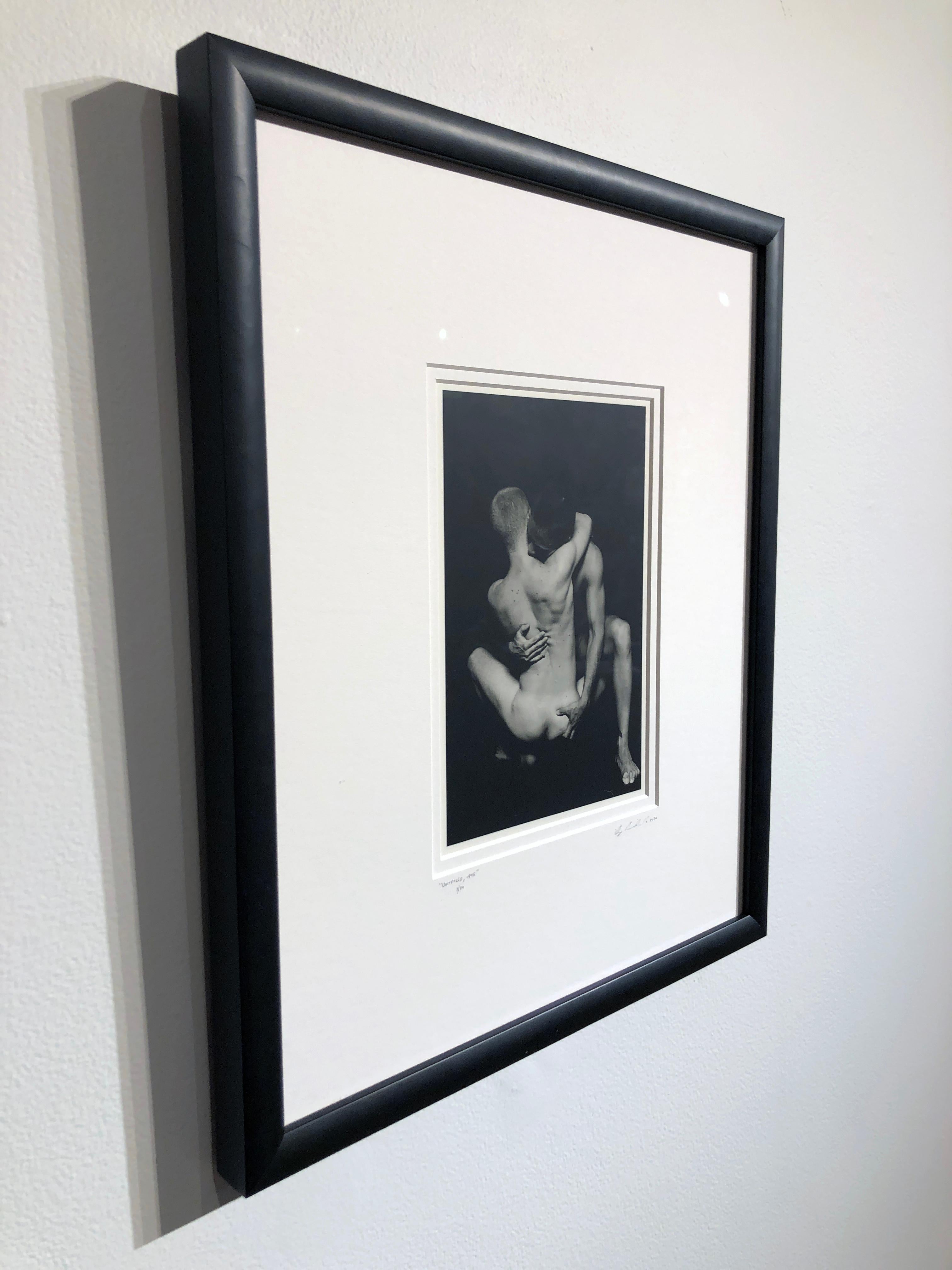 This intimate photograph shows two figures embracing, their faces are hidden, adding to its mystery.  The photo is custom matted  and framed in a black frame with non reflective museum glass.

Doug Birkenheuer
Untitled (Stone & Miles), 1995
silver