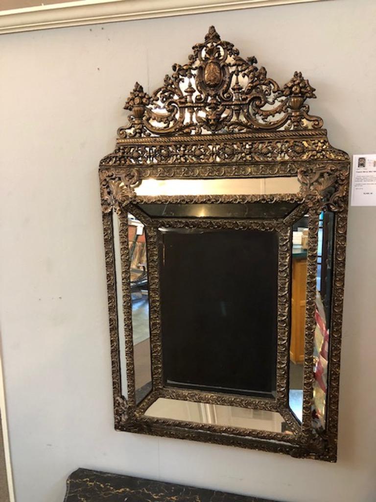 French Mirror Mid 19th Century
 
   French repose brass mirror, c. 1850s
 Repousse - shaped or ornamented with patterns in relief made by hammering or pressing on the reverse side - used especially on metal. 

  Condition is good. Some wear