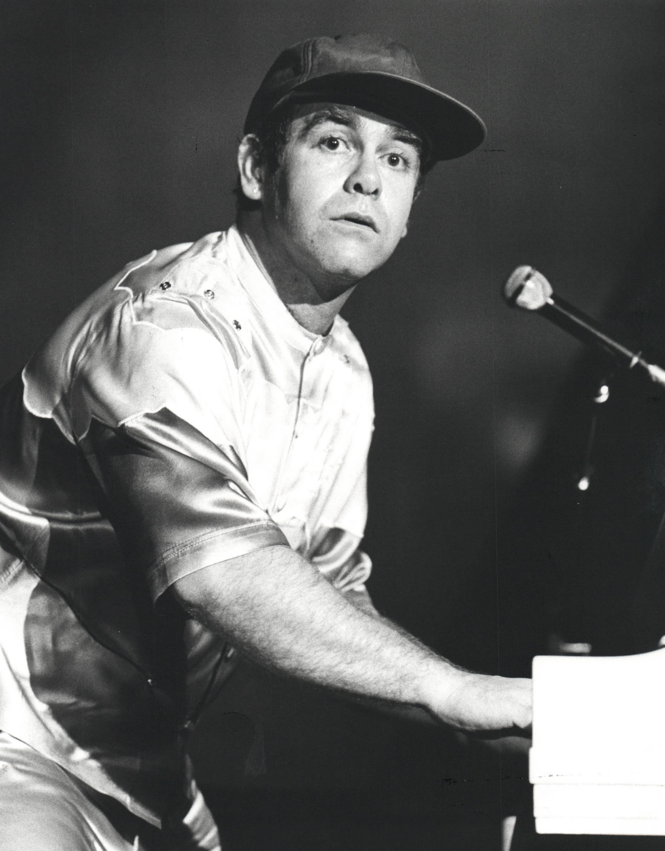 Phillip Ollerenshaw Black and White Photograph - Elton John Performing in Baseball Cap Vintage Original Photograph