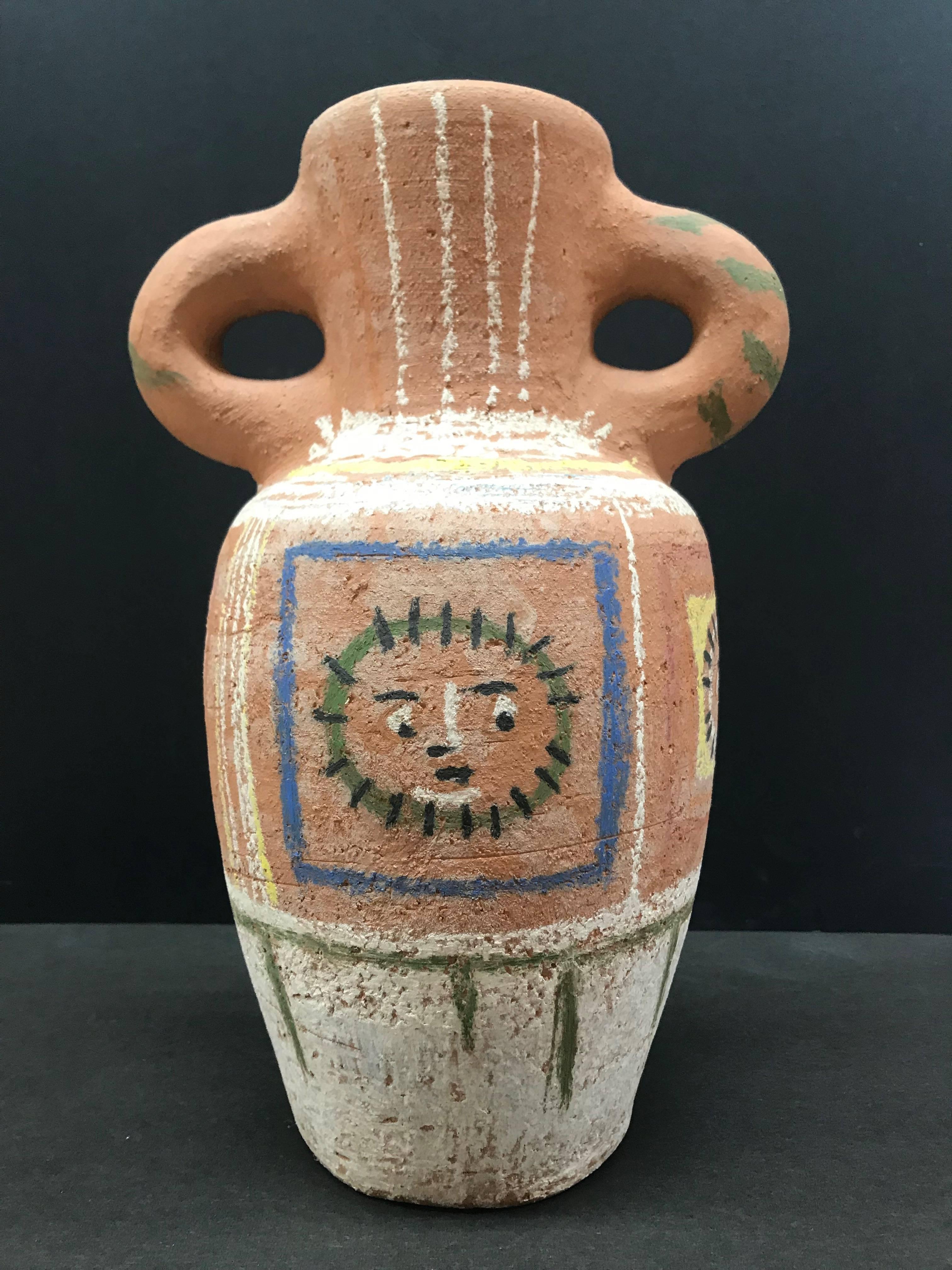 This piece is a turned vase by Pablo Picasso, created in 1953. It is made with chamotted red eathenware clay, decoration in pastels using white, green, yellow, blue and black. This piece is numbered 55/200 from the edition of 200 and bears the