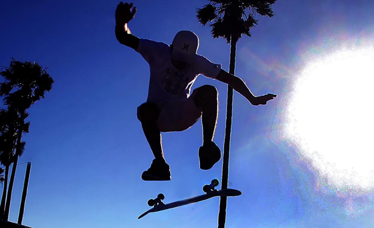 Chris Martinez Color Photograph - Skateboarder, Palms and Sun