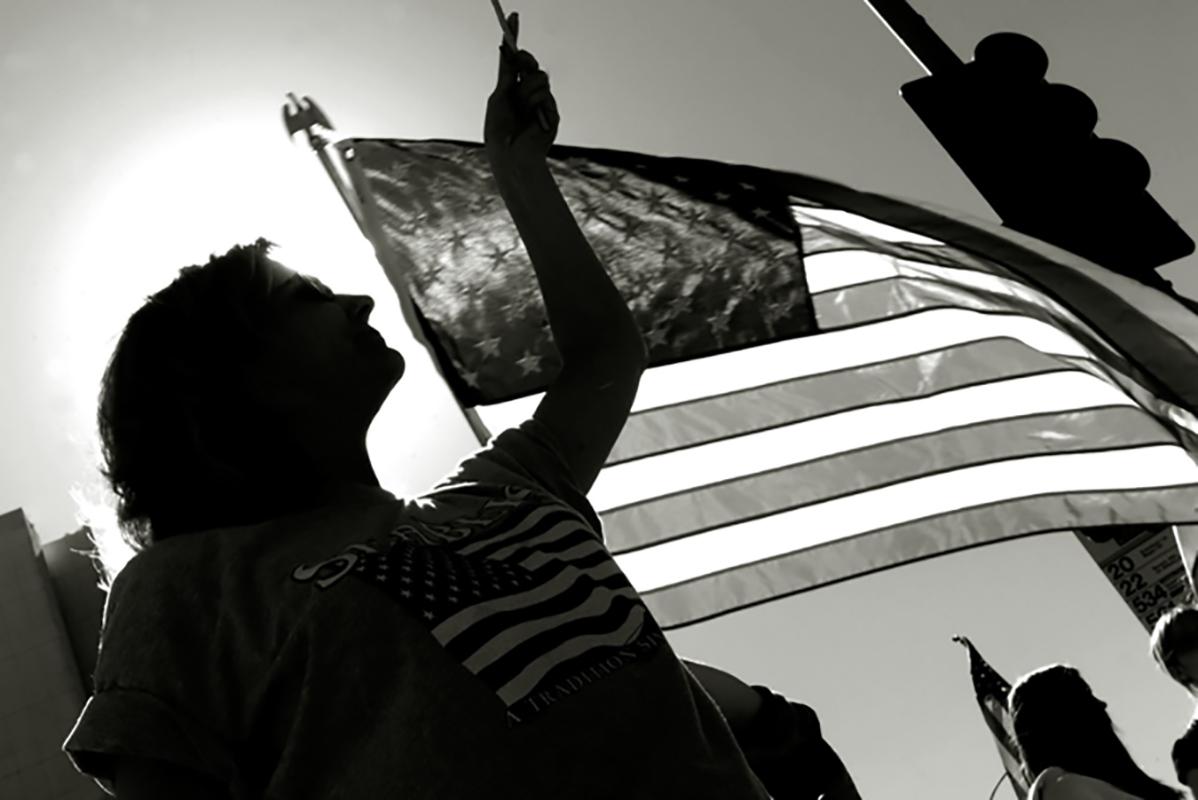 Chris Martinez Color Photograph – Woman and the Flag
