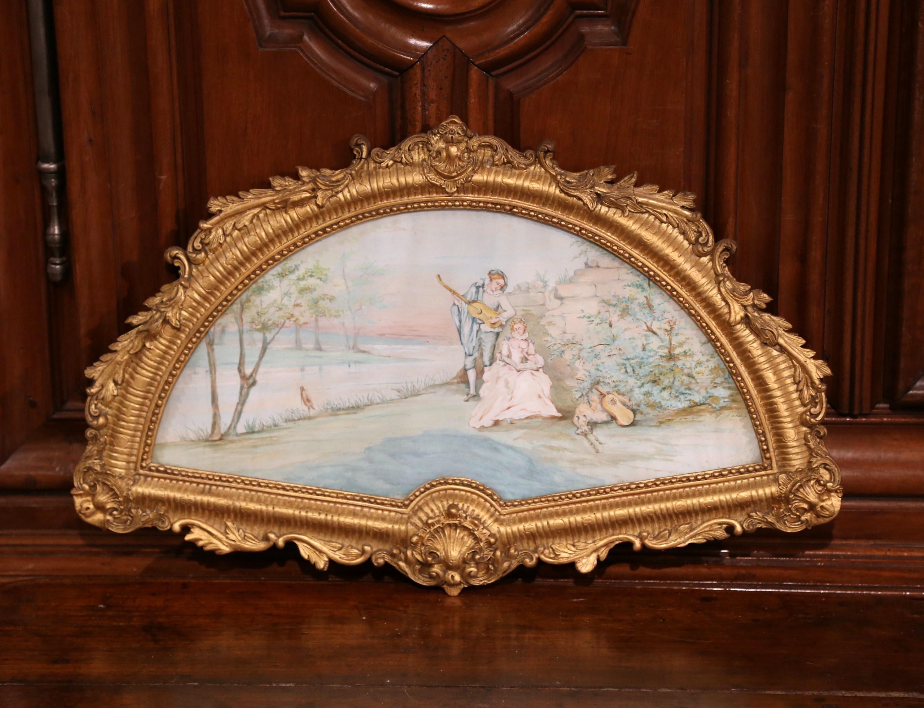 Shaped as a fan, this antique painting was created in Paris, France circa 1870. The elegant watercolor scene features a romantic courtly scene in which a gentleman serenades a young woman. The shape of the piece mimics an accessory (the fan) that