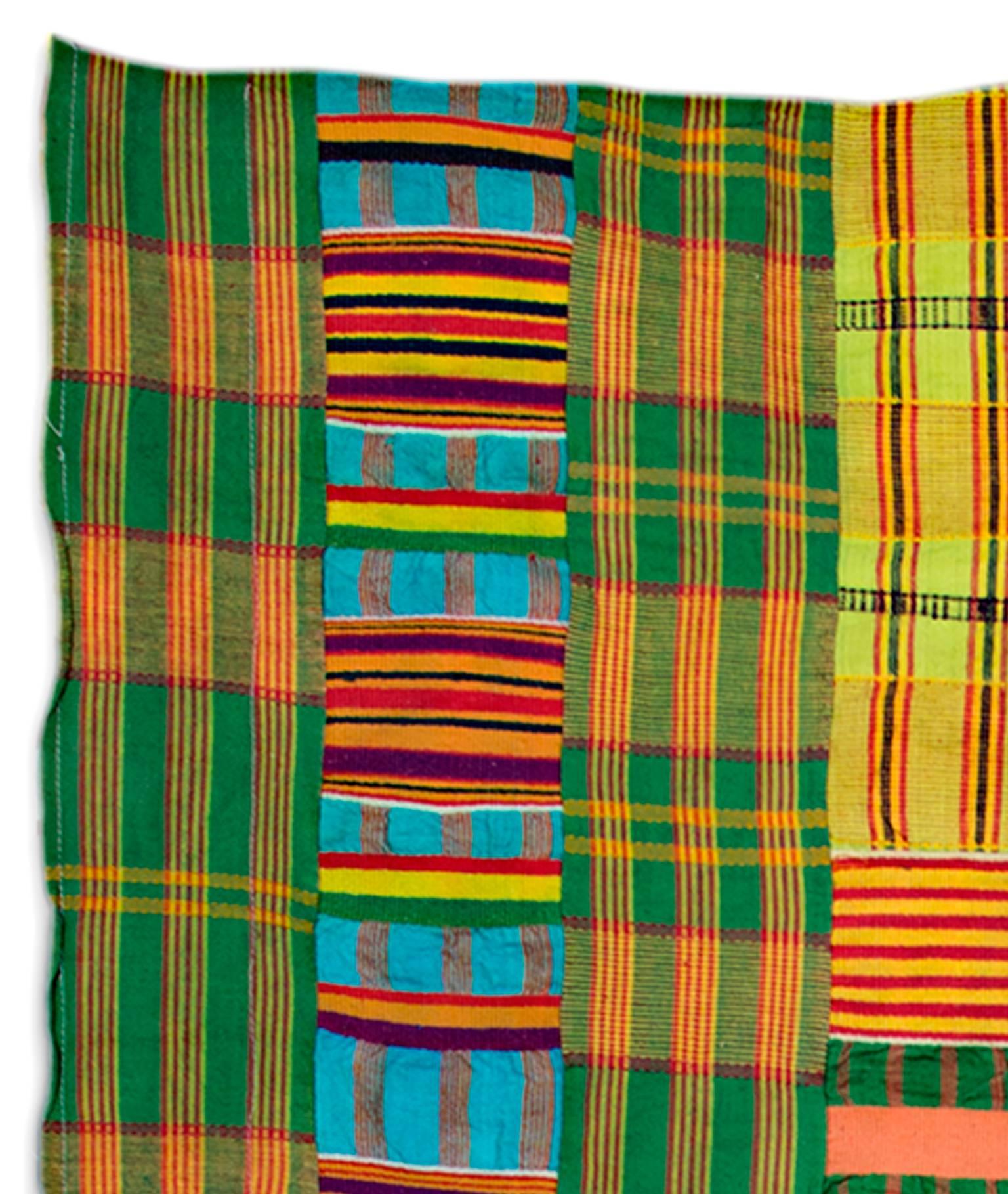This cotton fabric was made by an unknown Ewe artist. The Ewe people are an African ethnic group. This may be an example of Kente, a type of silk and cotton fabric made of interwoven cloth strips and is native to the Akan ethnic group of South