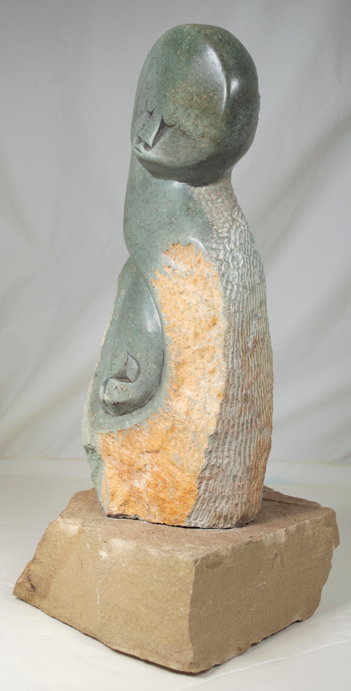 'Together' is an original opal serpentine sculpture by the Zimbabwean artist by Noel Mwanza. The sculpture presents a moment of motherly devotion, with a woman's tall figure embracing her child. Their faces are calm and content, with downcast eyes