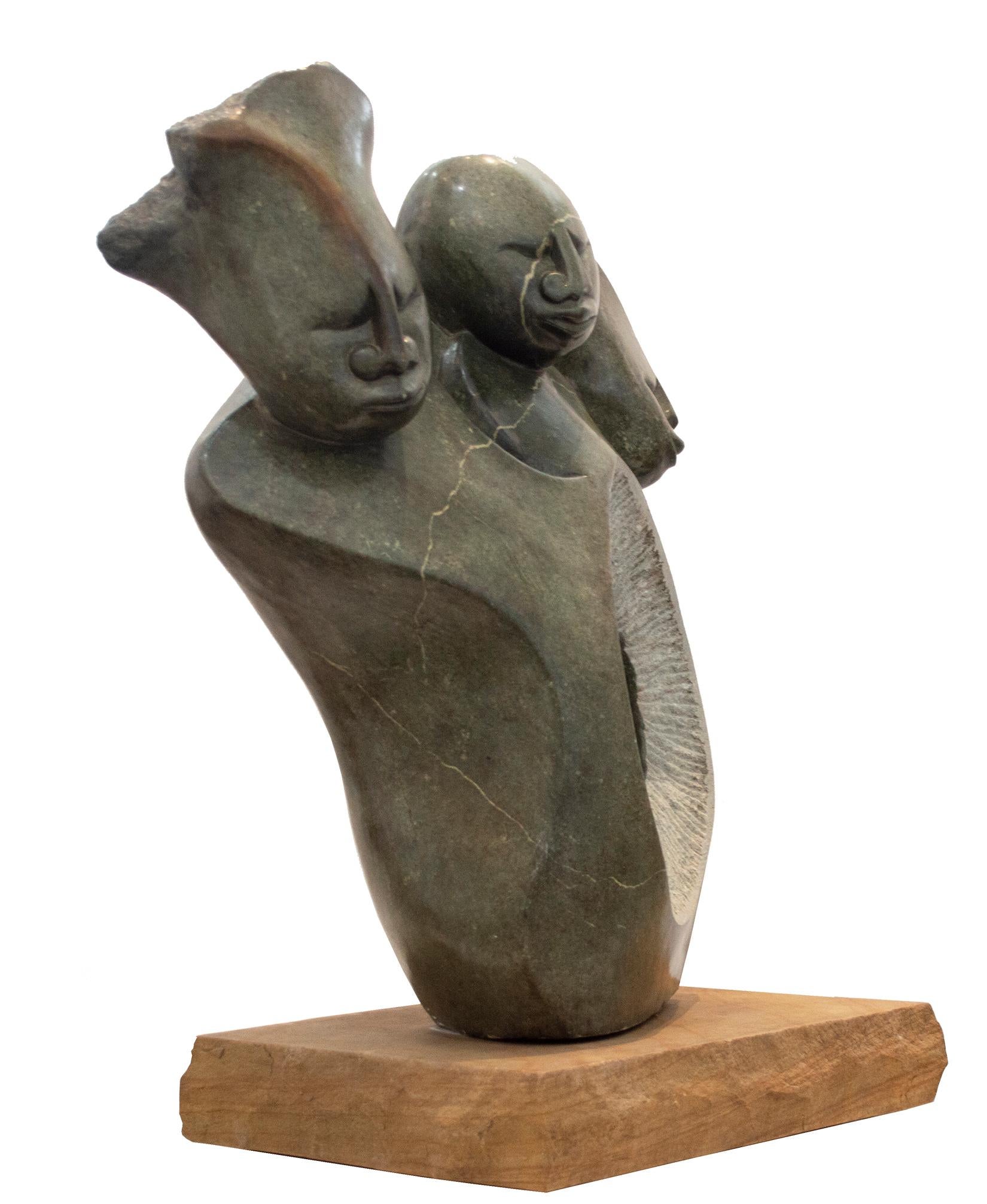 'Sharing One Heart' is an original sculpture carved from opal serpentine by the Zimbabwean artist Tichona Nyakambangwe. The sculpture presents three figures grouped together, representing members of a family. Each of their abstracted, mask-like