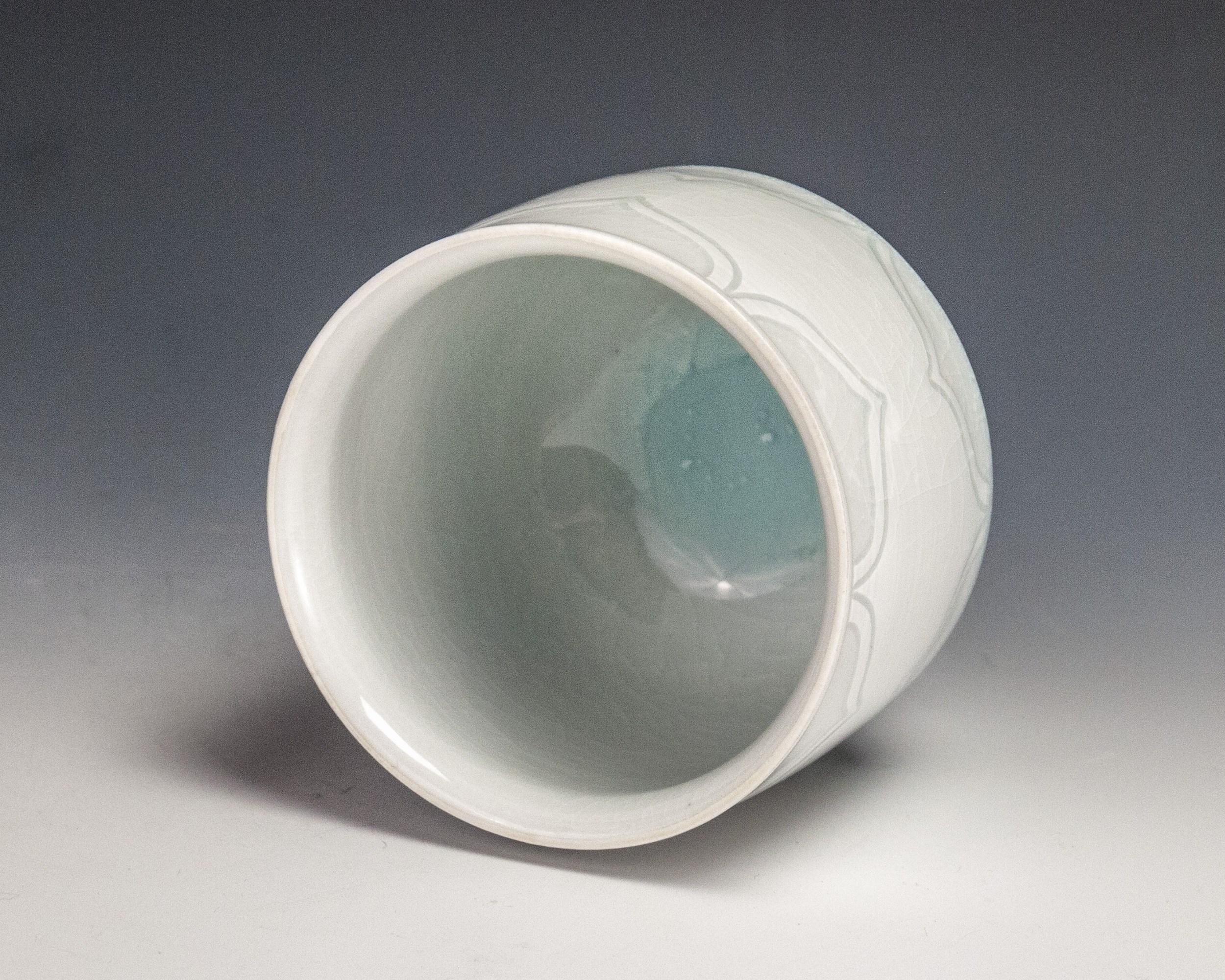 Sgraffito White Cup
Materials: Porcelain and Glaze
Date: 2018

Steven Young Lee has been the resident artist director of the Archie Bray Foundation for the Ceramic Arts in Helena, Montana since 2006. In 2004-05, he lectured and taught at numerous