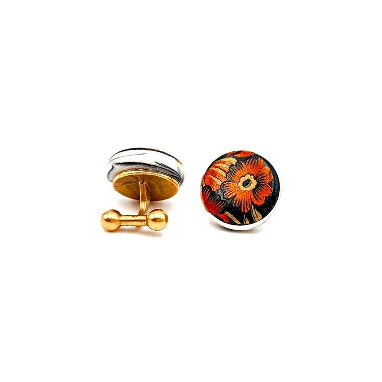 Melanie Sherman
Cufflinks with Red & Gold Flowers on Black Porcelain
Dimensions: 20mm x 17mm x 17mm
Materials: Porcelain, Glaze, Vintage Decal
Metal type: Brass
COA Provided

Melanie Sherman is a ceramic artist, born in Germany and currently