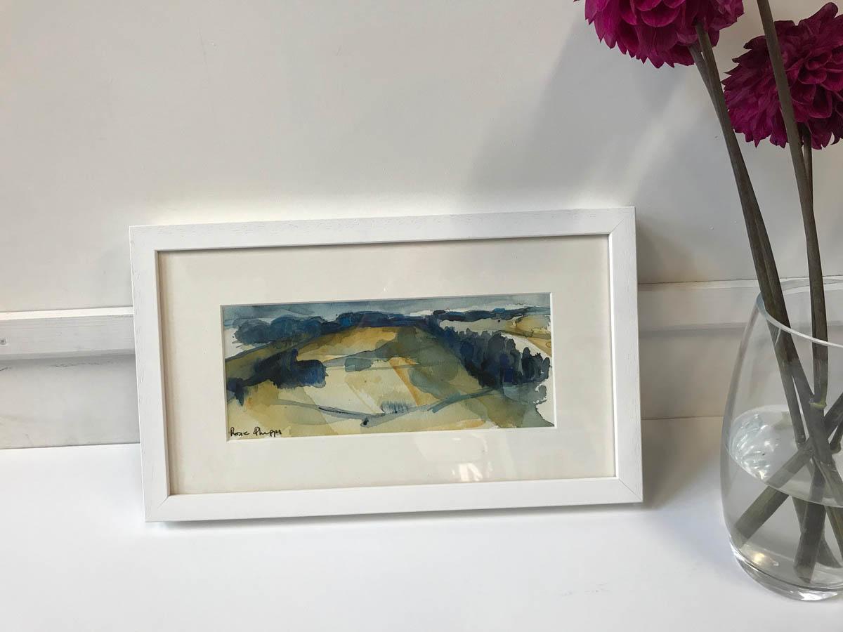 Cotswold landscape
Rosie Phipps
Landscape mixed media
Framed Size: W 40cm x H 23cm
Mounted Size: W 34.5cm x H 19cm
Image Size: W 25cm x 10cm
£250

Rosie says: ‘Painting is rather like a journey. One never knows if the journey will be short or long.