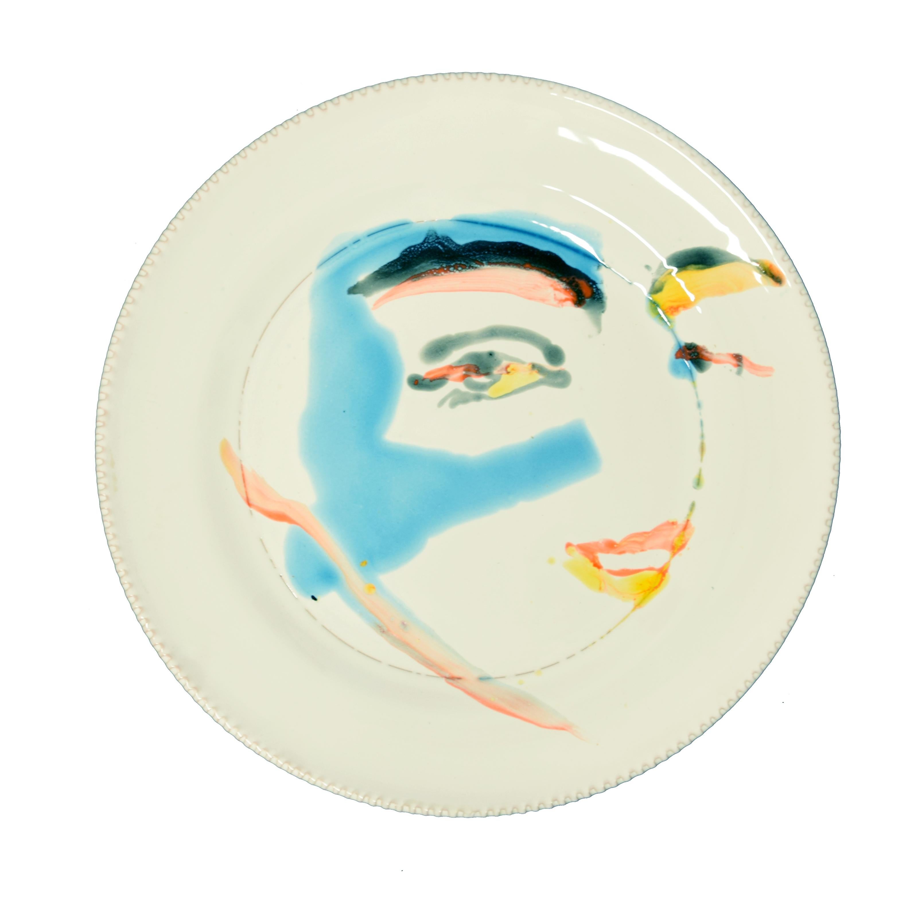 Eyes is a beautiful hand-made flat ceramic dish realized by the Russian artist, Anastasia Kurakina in 2019. 

On the back at the center the blue stamp 