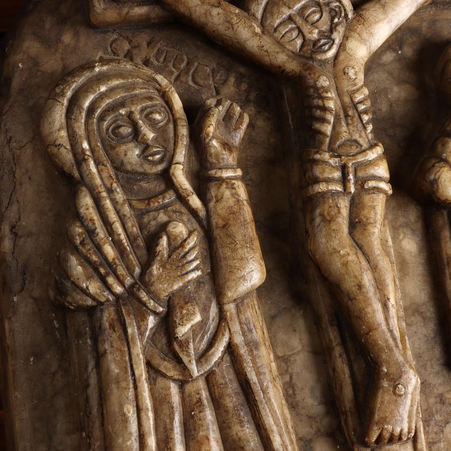 This stone icon depicts the Crucifixion at the top and Calvary at the bottom. At the foot of the Cross is Our Lady and St. John the Evangelist. The tormentor who flogs Jesus on his ascent to Golgotha is portrayed in profile as is generally the case