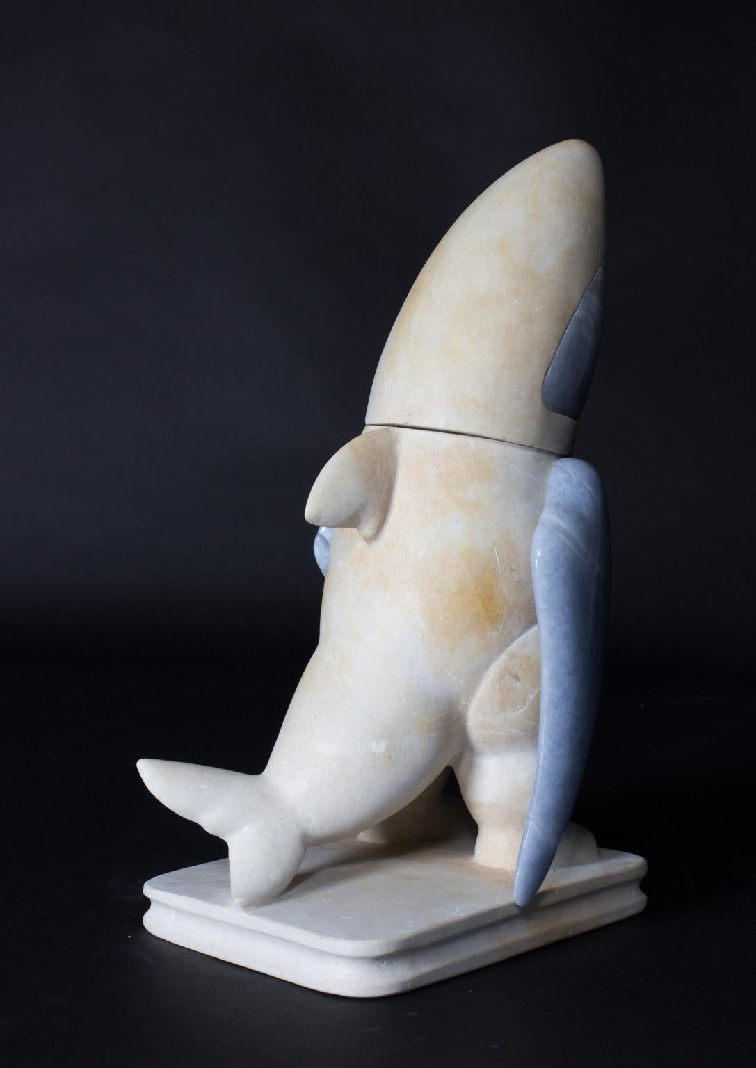 The Explores. Nº 9 The Shark by Spanish sculptor Mario Romero
Technique: Sculpted stone 
Material: Blue alabaster and Cream marble.
Measures: 38 H x 22 W x 17 D cm
Weight: 10 kg

The treatment of the volume, accompanied by fine and subtle details of