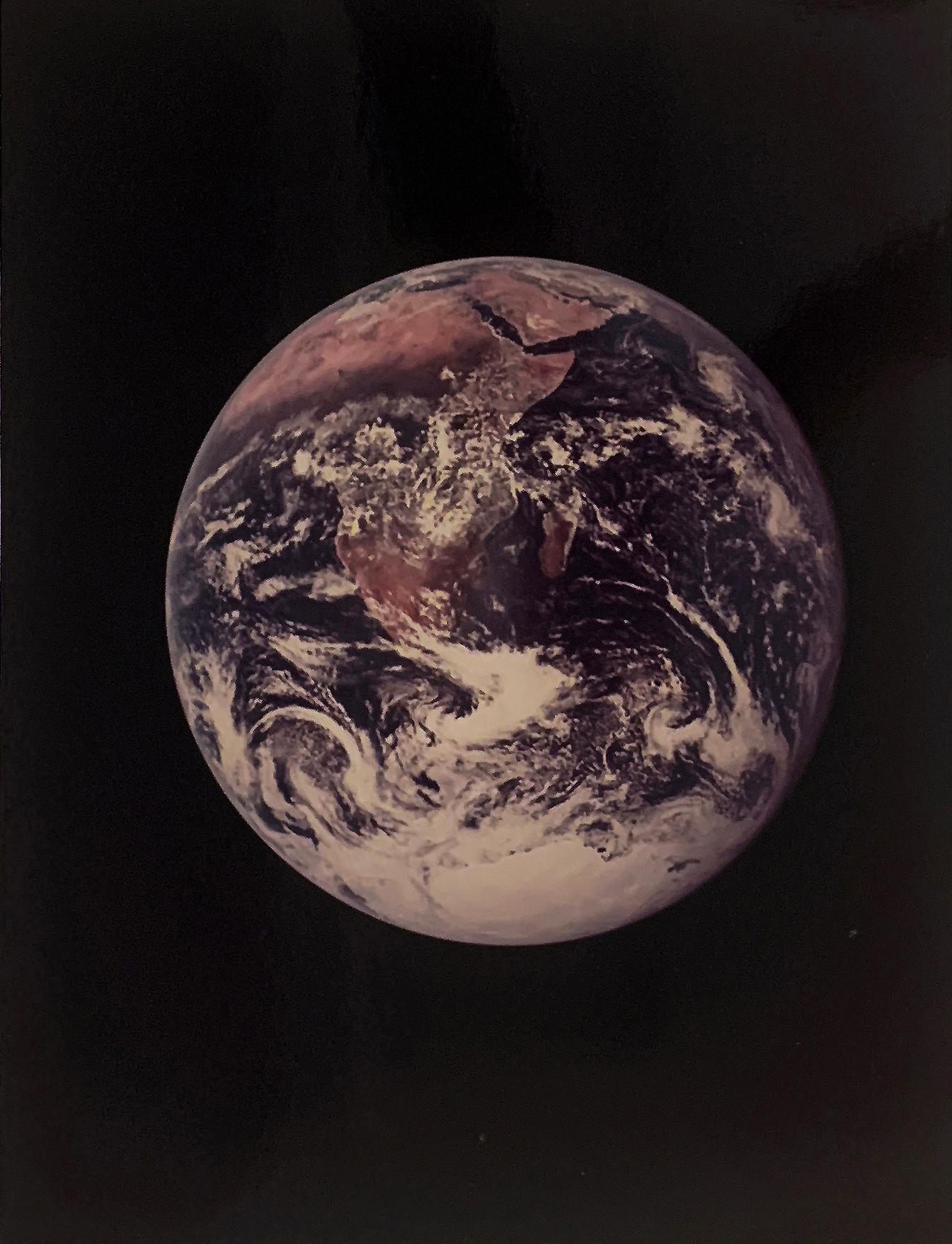 The Blue Marble is the first photograph of the full Earth seen by human eyes, December 7-19, 1972.
The photograph is an iconic image from the Apollo 17 Moon Mission by NASA astronaut Harrison Schmitt. 

Since NASA first released Blue Marble, the