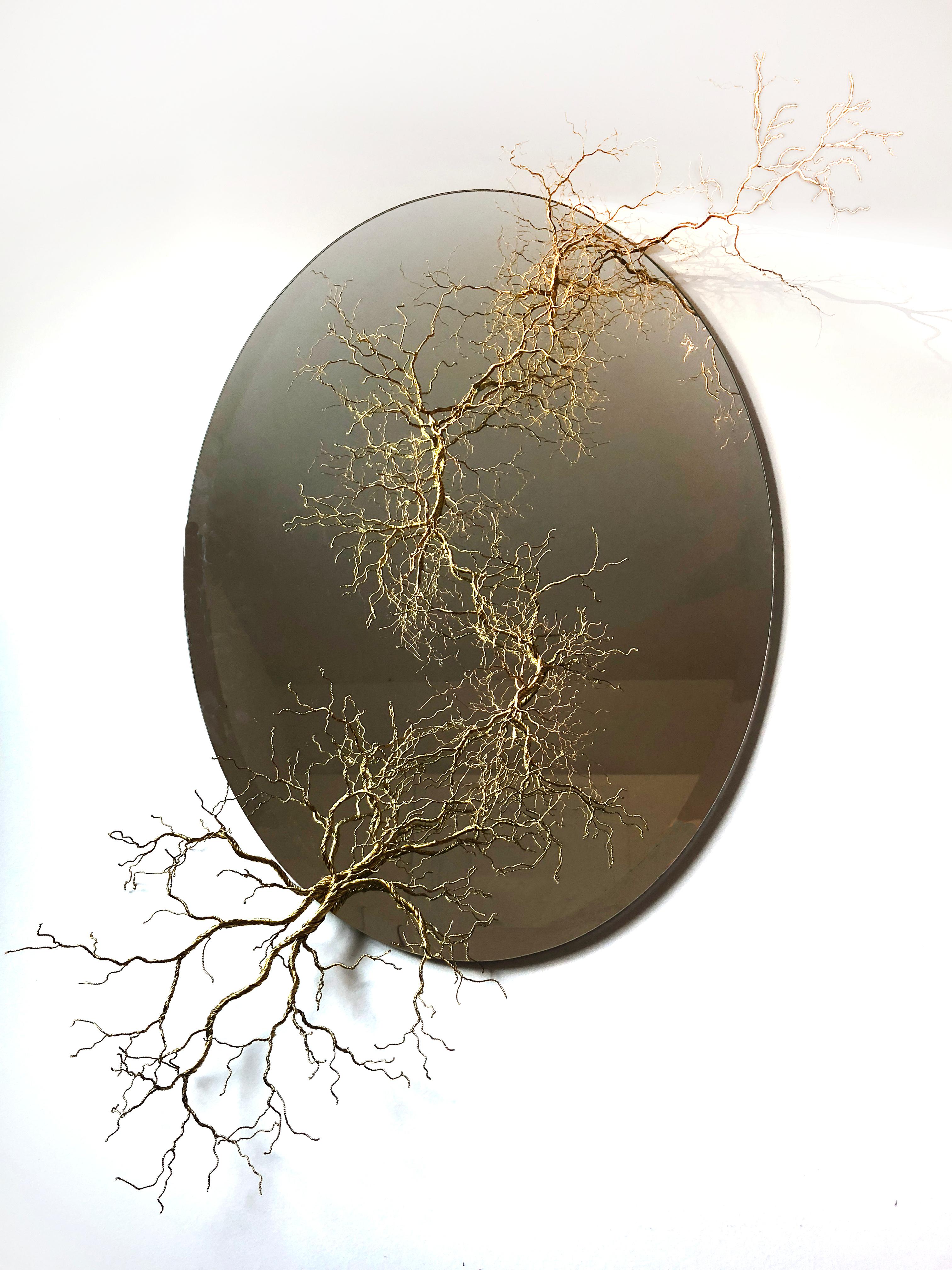 Large fine art brass wire sculpture on oval mirror by Amelie Guthrie.

Amélie Guthrie grew up in New Orleans before studying art history at Vanderbilt University. Thereafter, her adoration for art continued to flourish, and she worked in different