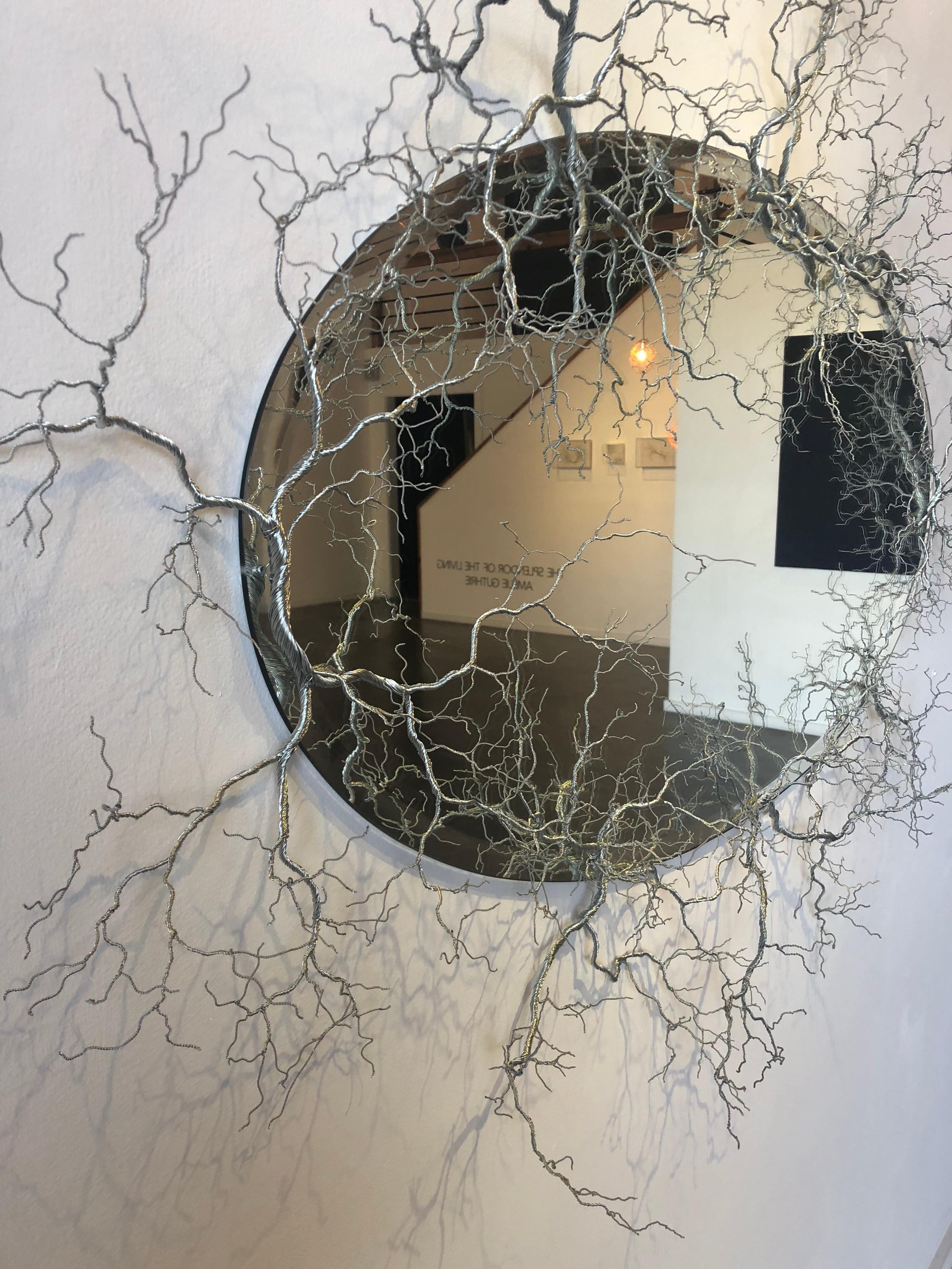 Large fine art wire metal sculpture of tree branches surrounding an oval mirror.

Amélie Guthrie grew up in New Orleans before studying art history at Vanderbilt University. Thereafter, her adoration for art continued to flourish, and she worked in