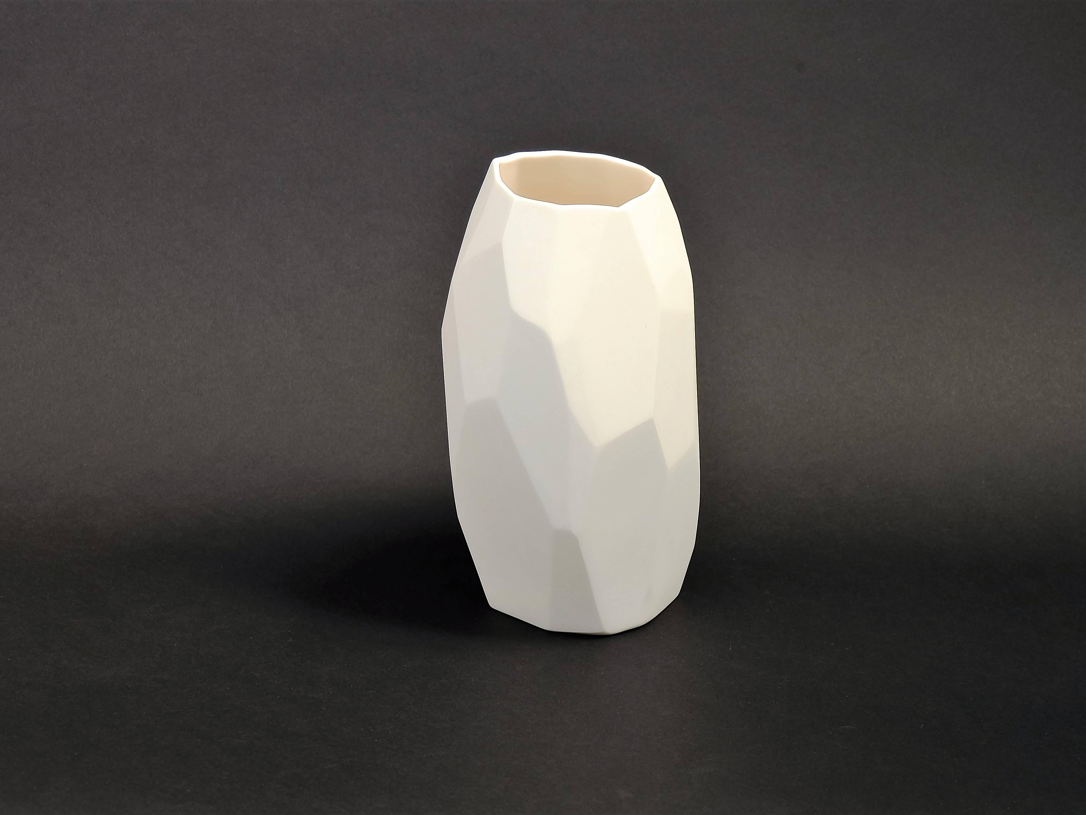 A handmade unglazed (biscuit) porcelain vase made by design duo Vezzini & Chen.

Inspired by rock formation, it is a limited edition of 15 but each one is different because entirely handmade. The surface is hand carved following the faceted form of