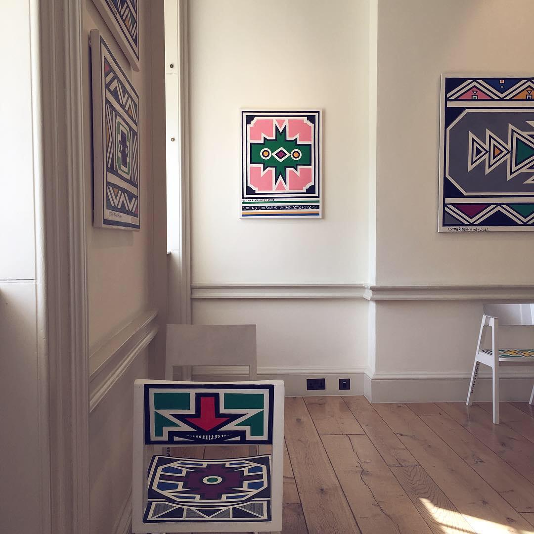Esther Mahlangu (b. 1935) is a South African artist from the Ndebele nation. She learned mural painting from her mother and grandmother at a young age, following the Ndebele cultural tradition of women painting the exteriors of buildings in their