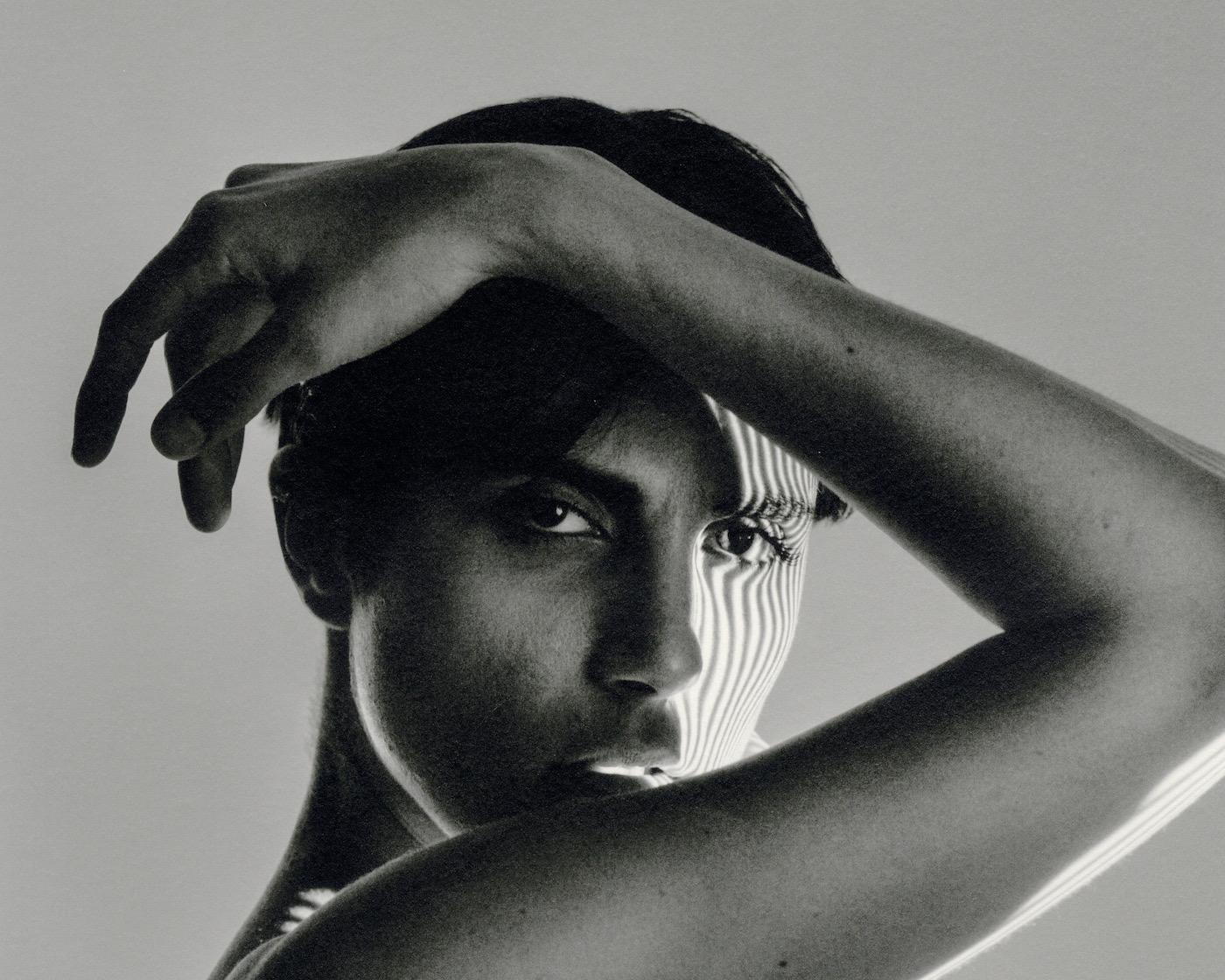 Roarie XVII (Nude in Shadows looking through arm) - Photograph by Laurence Winram