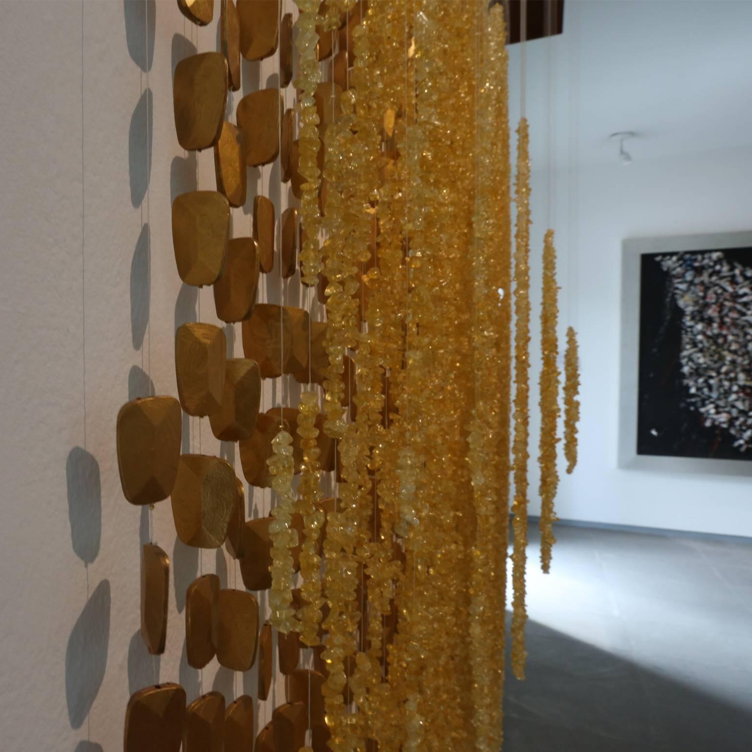 Mexican Handmade Contemporary Art

Elegant and shiny

This piece is all hand made in Mexico City. The 12,250 beads with a translucent amber finish were strung individually on threads and held with golden metal miniature cubes. The first suspended