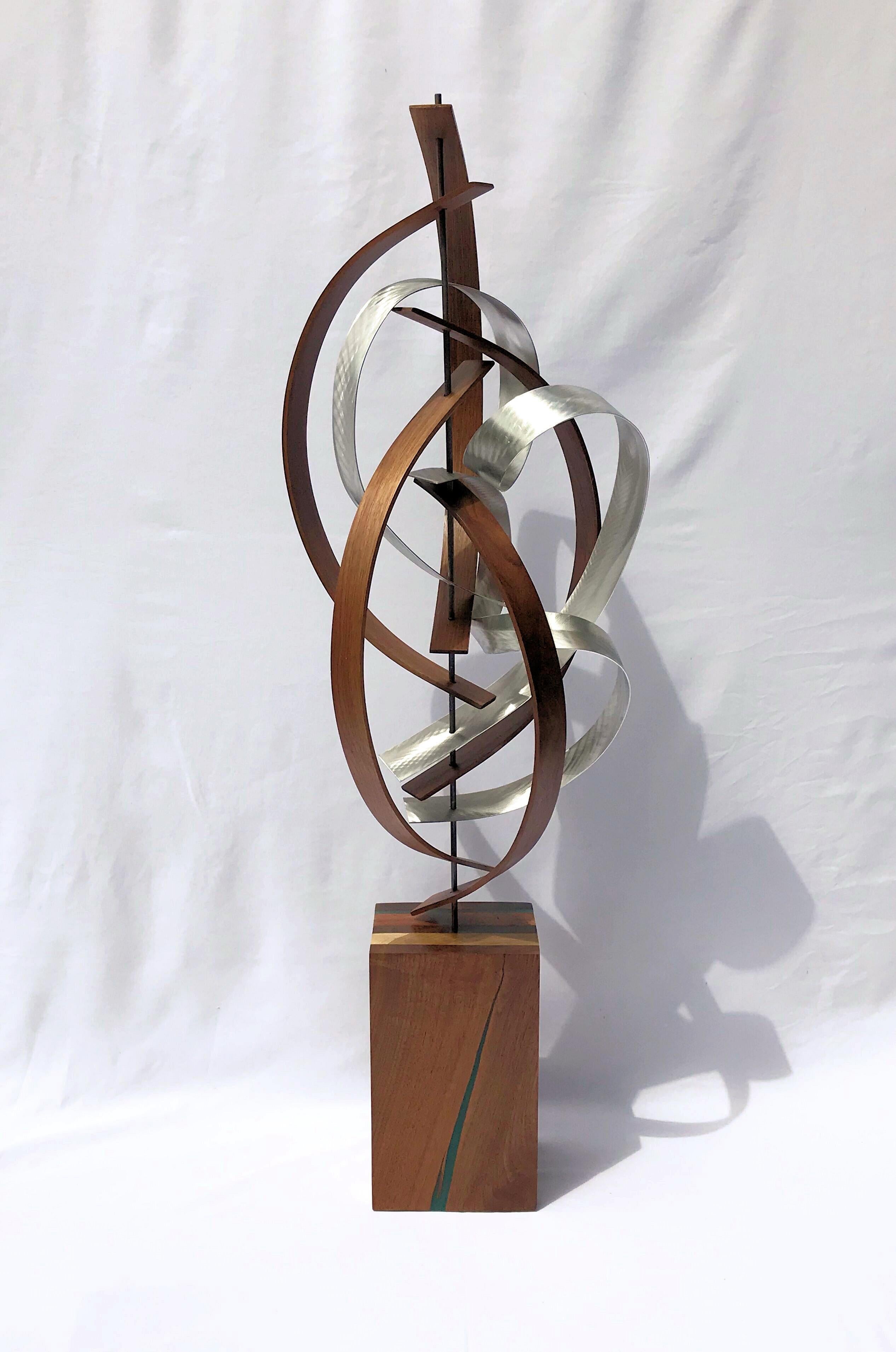 Title: Bubbly
Description: Black walnut slats bent about a steel rod with bubbling ground aluminum accent strips. Sculpture base features laminated walnut, cherry, poplar with a turquoise epoxy inlay and a satin finish.

Jeff Linenkugel was born and