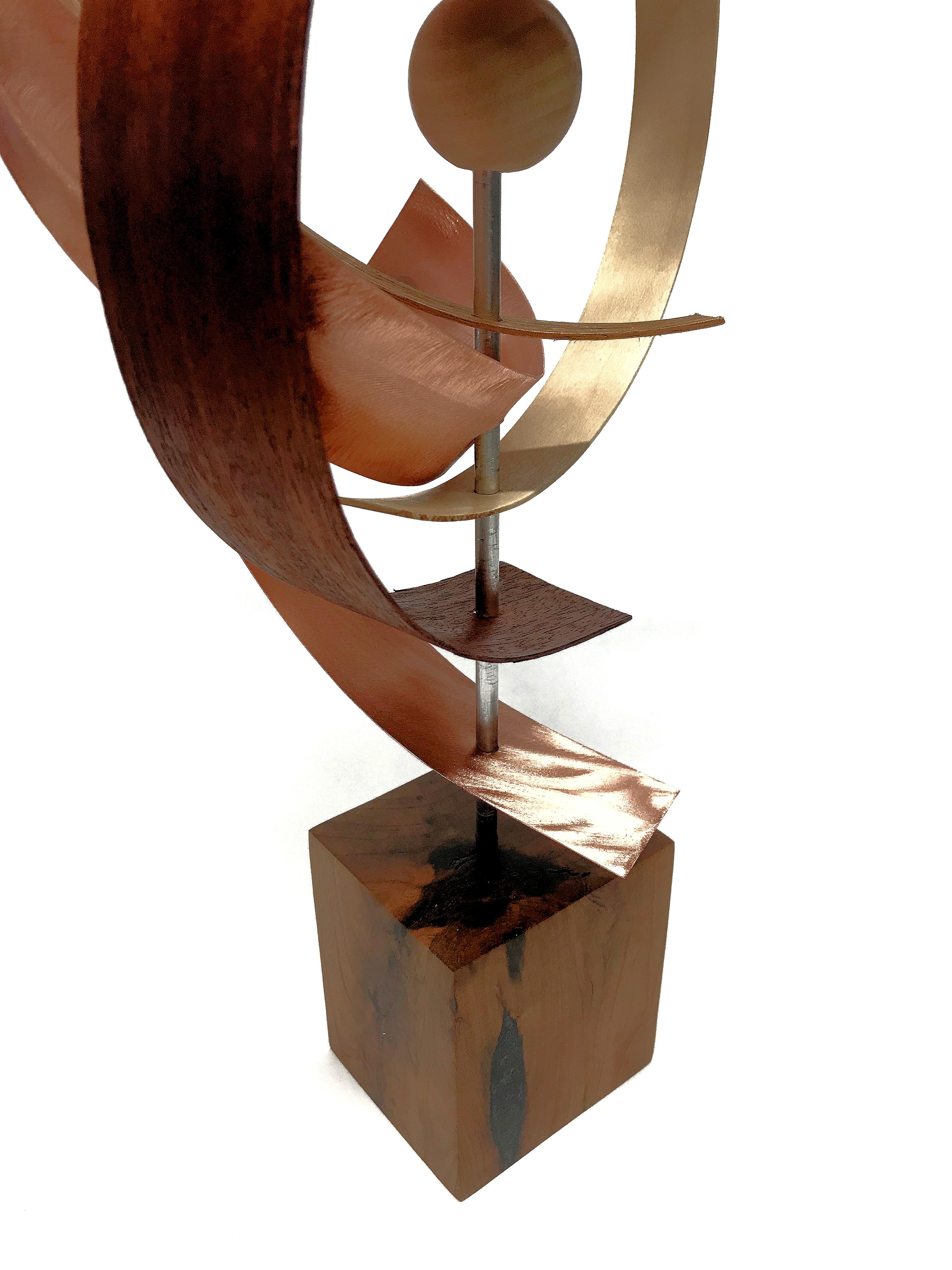 This Mid-Century Modern Inspired Wood Sculpture is comprised of hickory black walnut mahogany with hand-ground copper and a wooden sphere accent. The base is solid cherry complimented with pewter epoxy inlay. 
Title: Waltz
Artist: Jeff