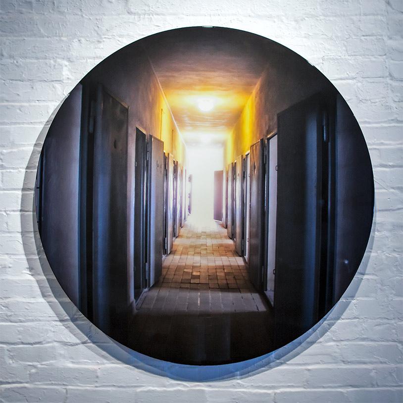 Title: Captives Set Free
Artist: Collin R.
Dimensions: 42"(d)
Limited Series: 2 of 250

High quality original photography printed on metal with clear coat finish. Wall floating .75". Includes hanging system. 42” diameter. 

  I visited Sachsenhausen