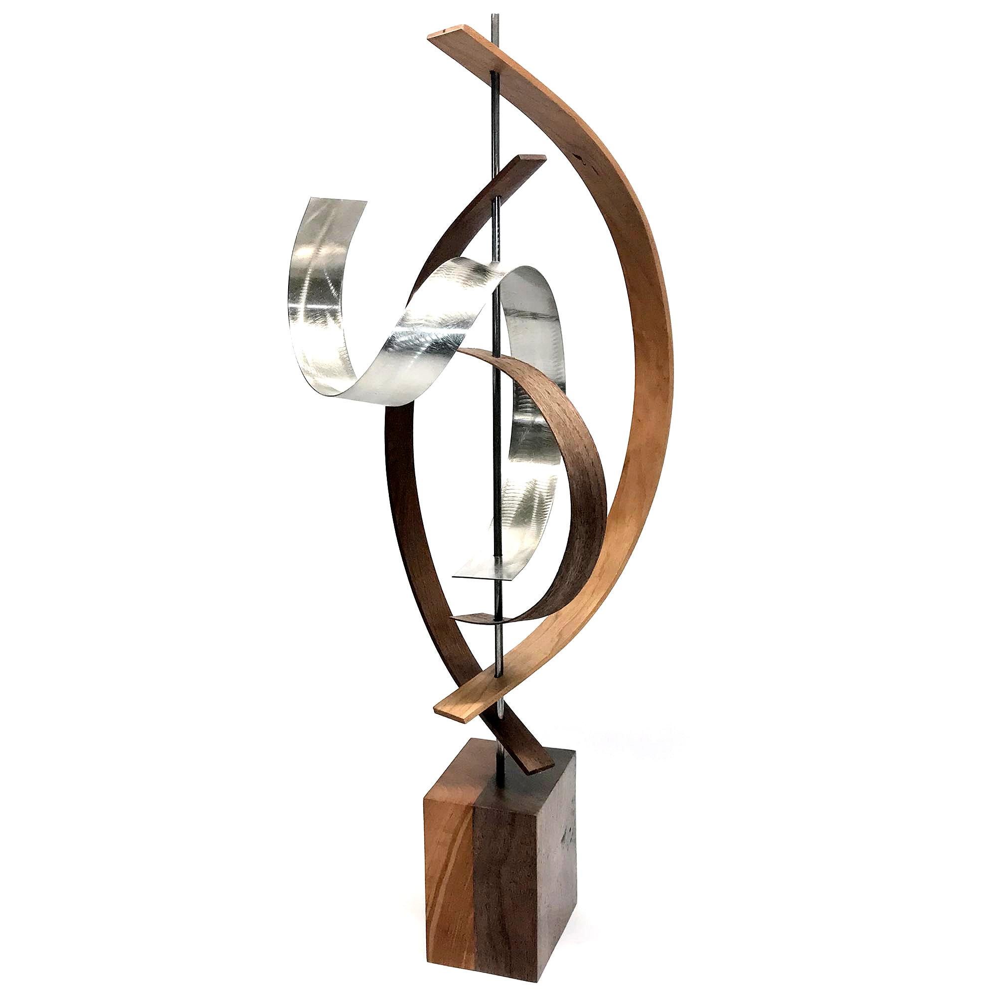 Description:  This sculpture consists of formed walnut and cherry wood, aluminum slat with custom grind. This sculpture is an open-edition multiple original; hand-made by the artist.
Title: Lift

Artist Bio:
Jeff was born and raised in Toledo Ohio